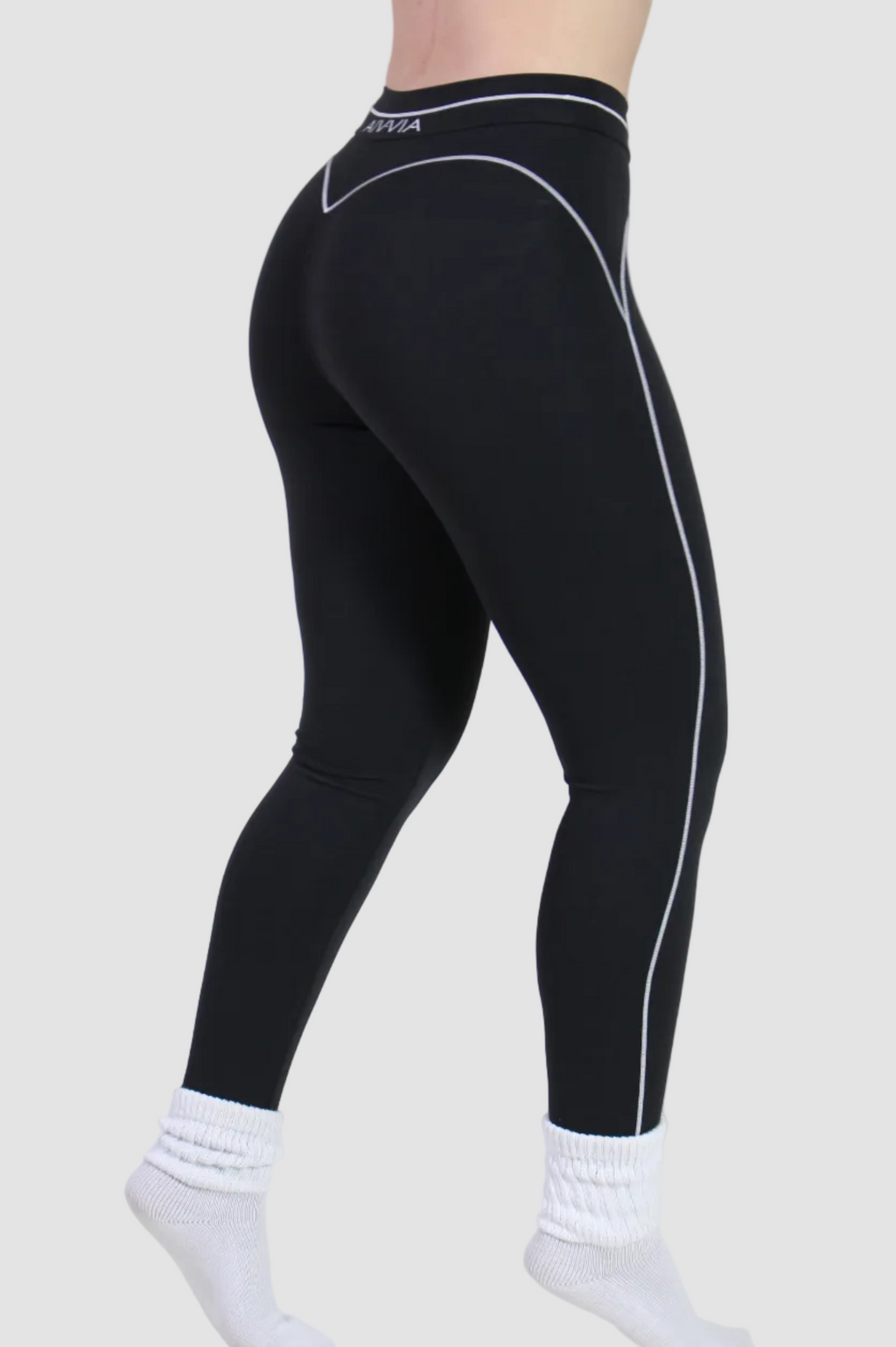 Side view of black sculpt sports leggings showing thick supportive straps and compression fit, perfect for yoga, pilates, and gym training.