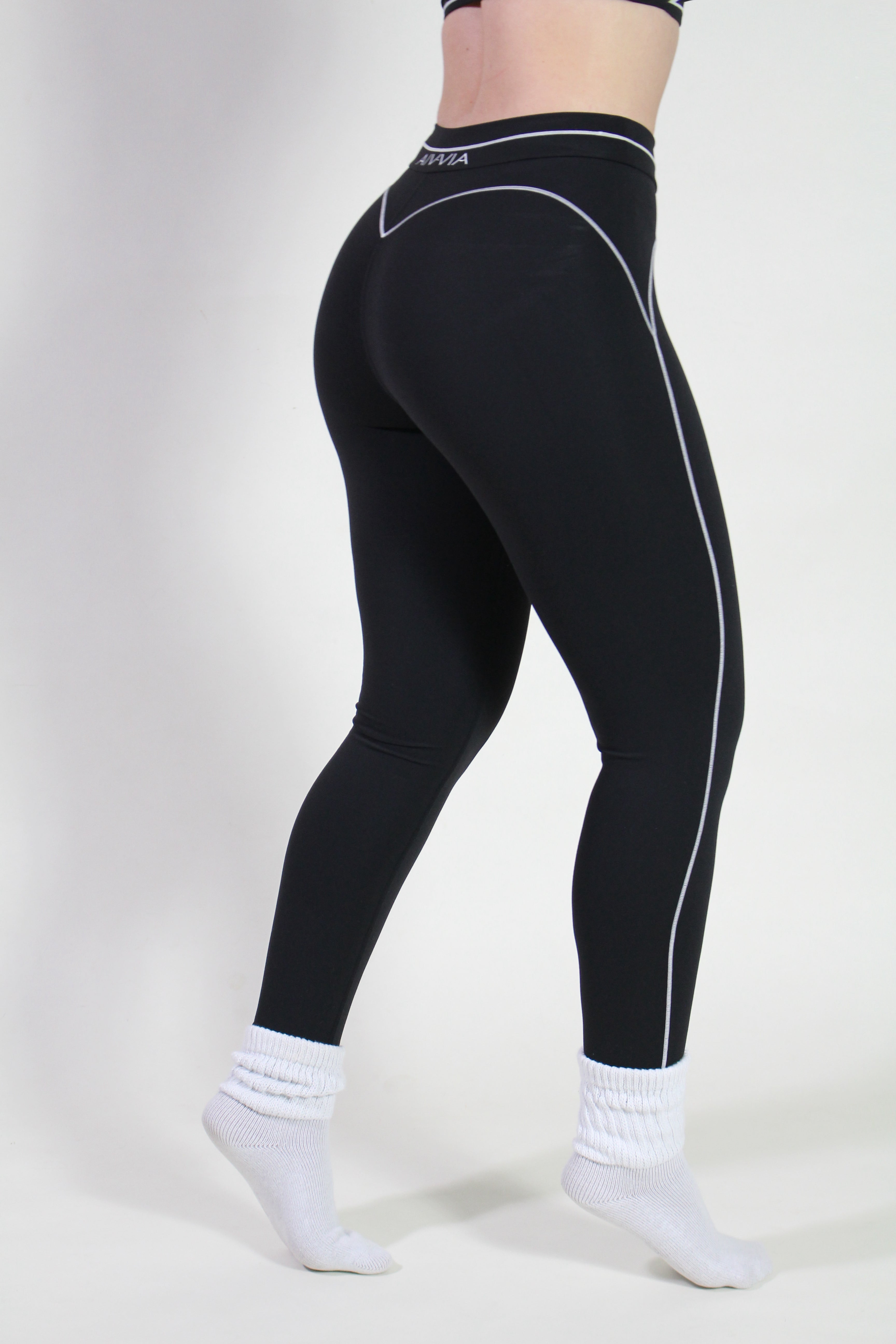 Side view of black sculpt sports leggings showing thick supportive straps and compression fit, perfect for yoga, pilates, and gym training.