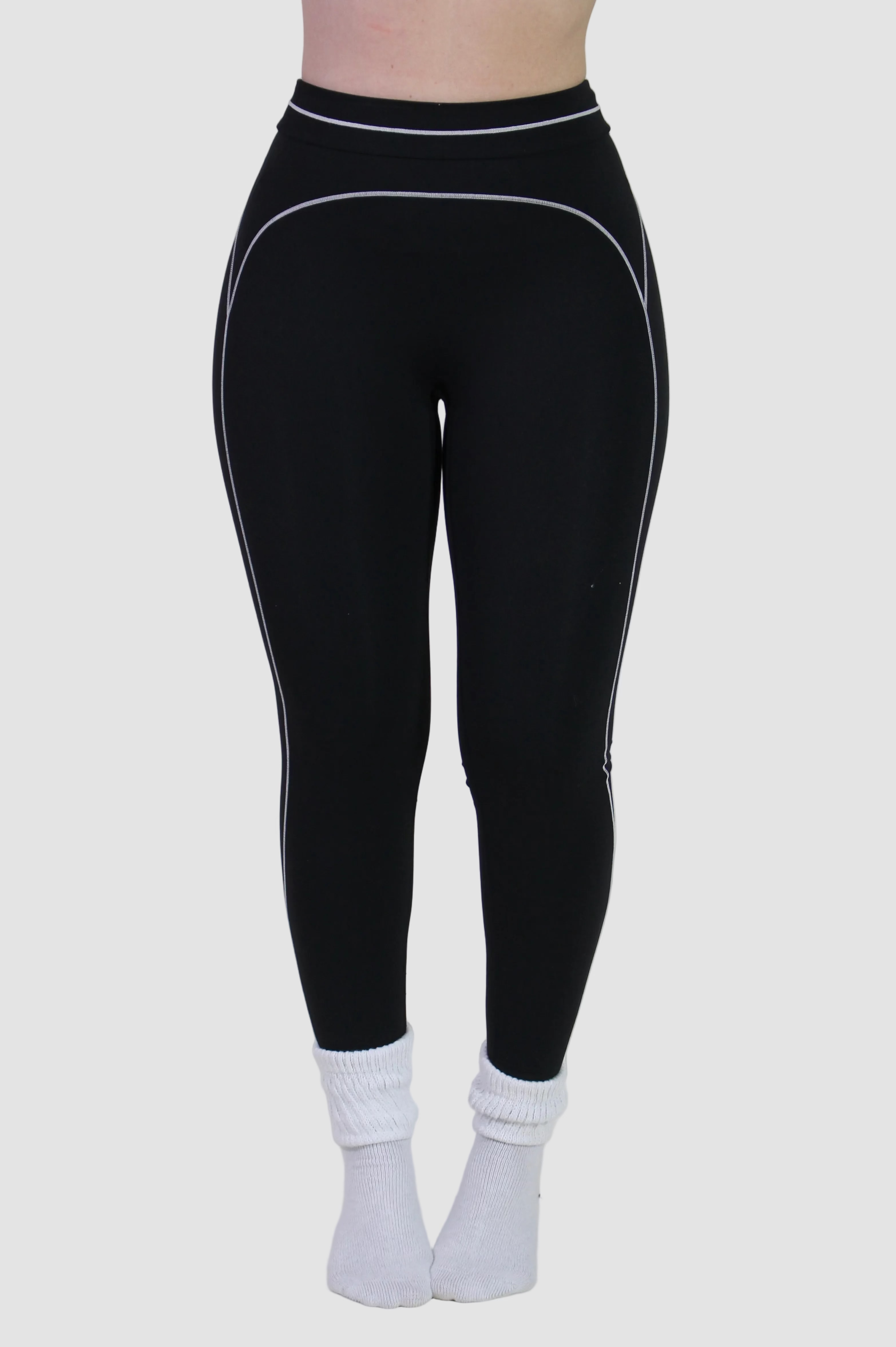 Front view of a woman wearing Onyx Black Sculpt leggings, featuring high-waisted fit, ideal for gym, pilates, and active workouts.