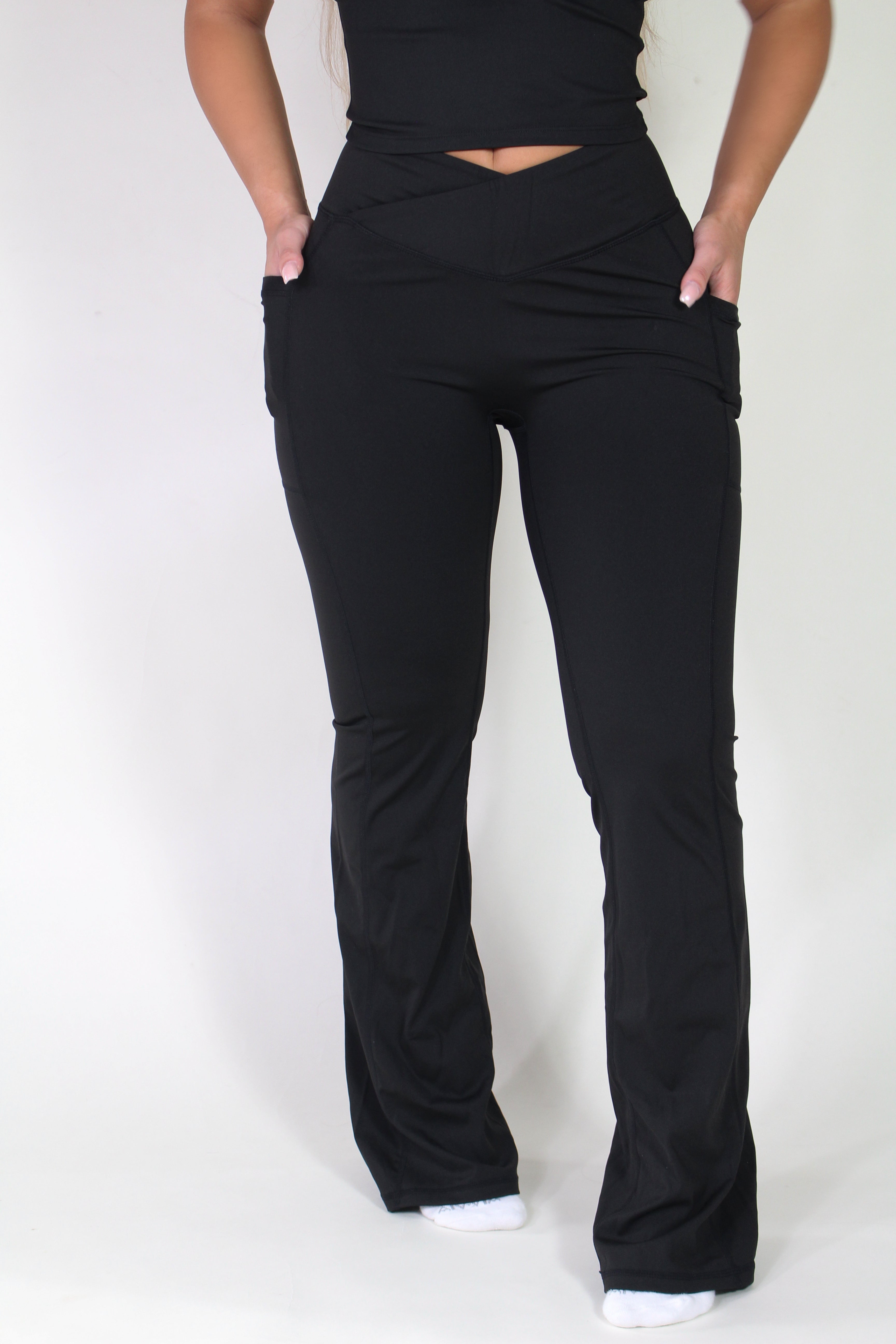 Three-quarter front view of Aivvia Athletics sculpt pants, showing smooth compression fit, crossover waistband, and premium athletic styling.