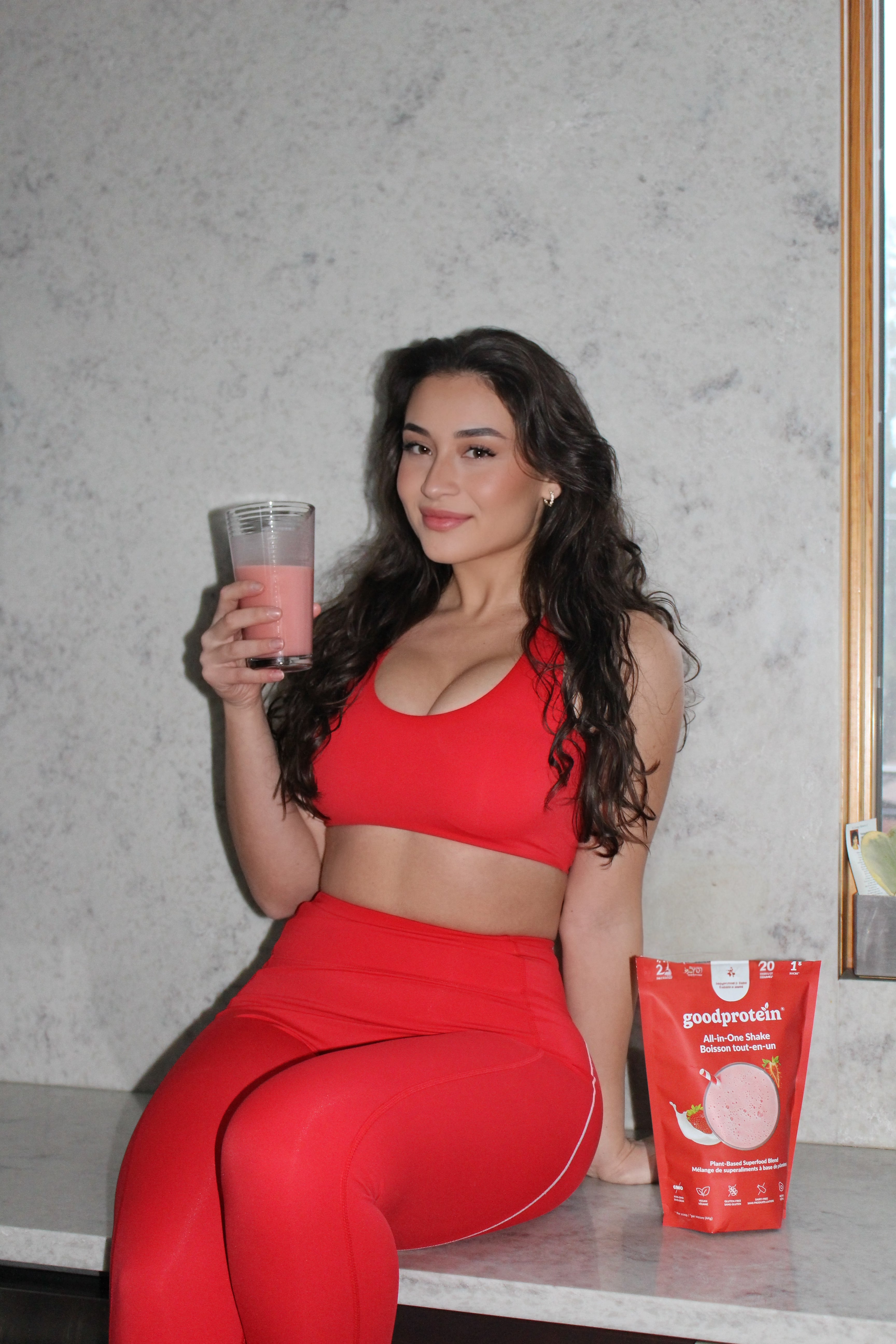 Front angled view of Aivvia Athletics red sports bra, showing seamless side construction and robust support.