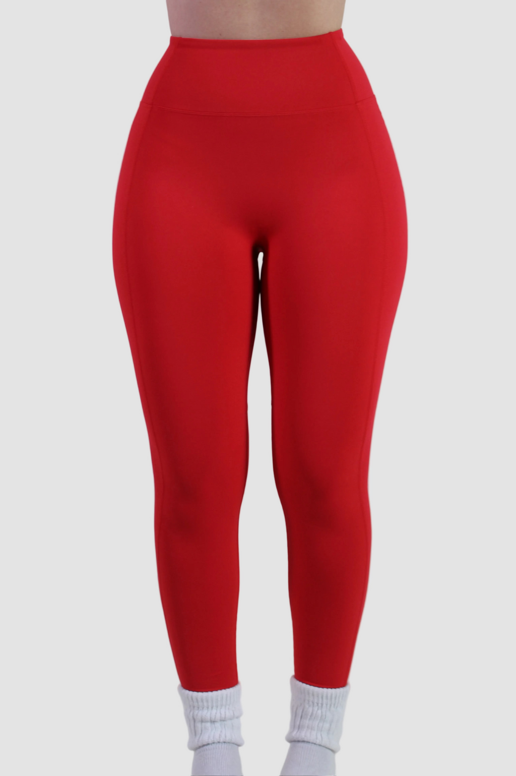 Front view of Aivvia Athletics red high-waisted leggings with smooth front panel and secure waistband for gym and yoga.