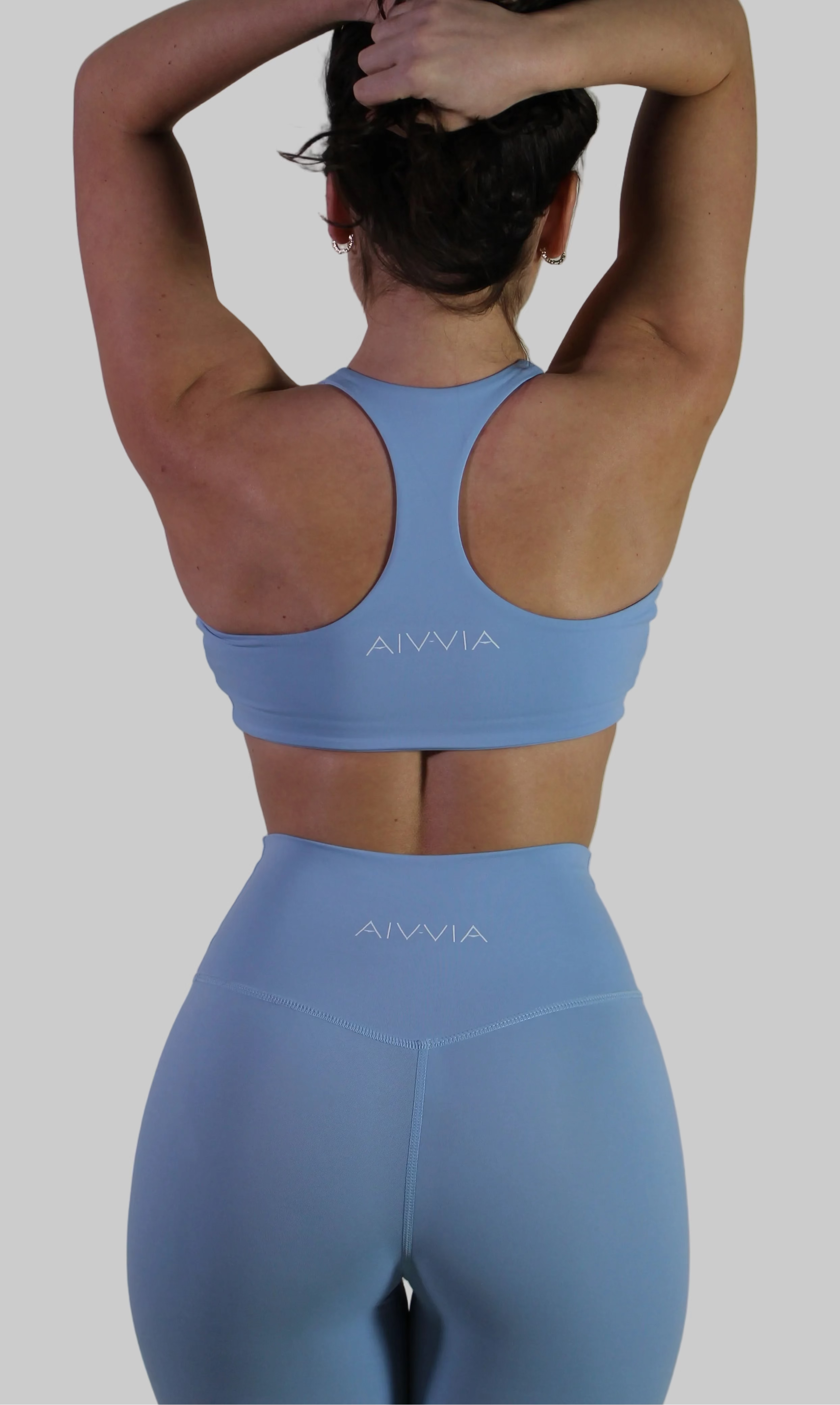 Back view of Aivvia Athletics baby blue leggings, showing high-rise waistband and sculpting seams for women’s workout leggings.