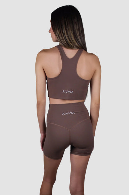 Back view of the chocolate brown activewear set with a racerback top and fitted high-waisted biker shorts.