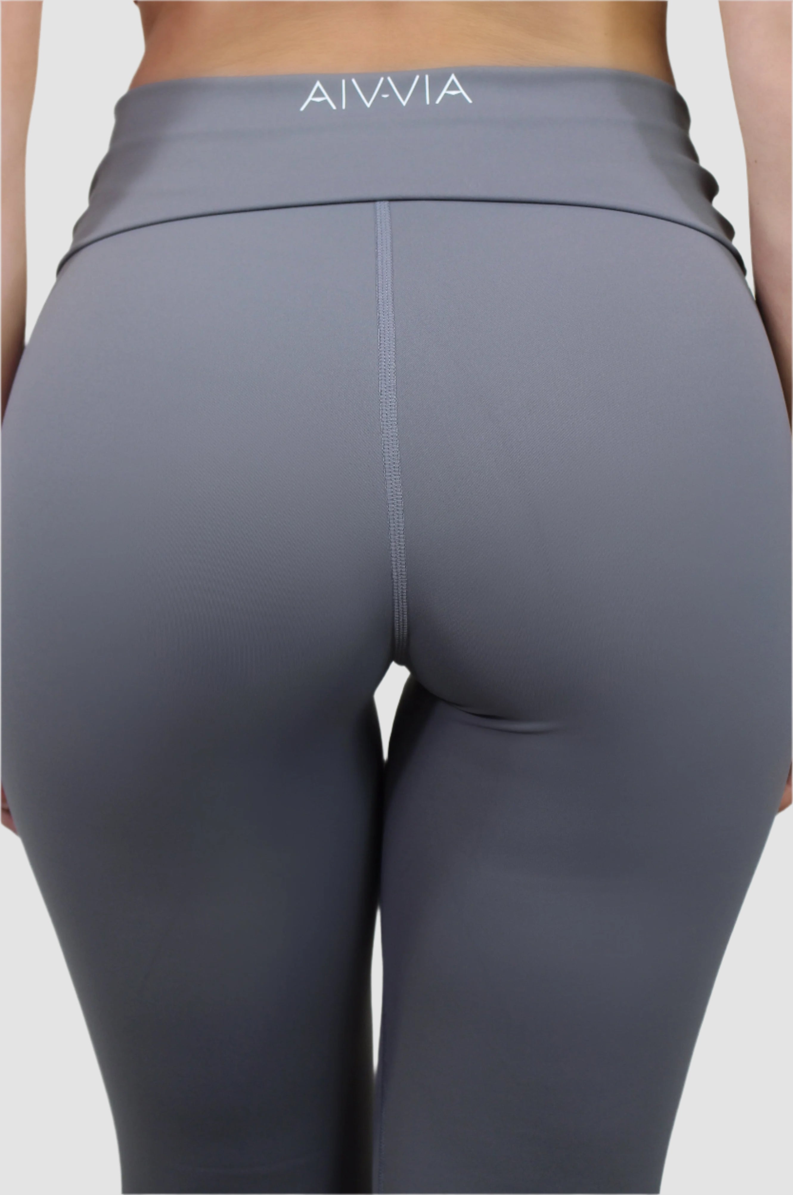 Back view of gray Aivvia Athletics flared yoga pants featuring logo detail and smooth, stretch-fit fabric.
