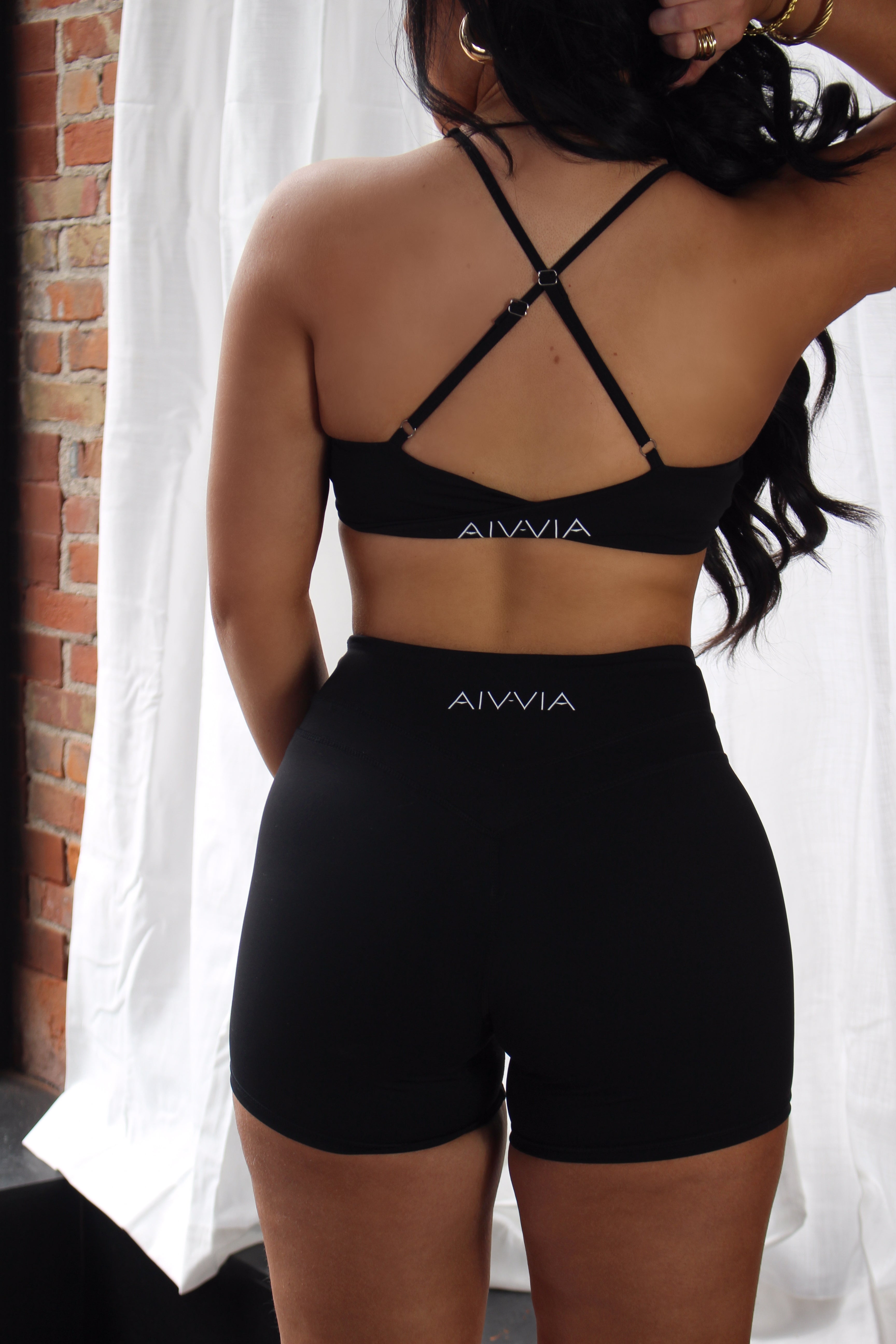 Back view of black Aivvia Athletics sports bra; elasticated band and strappy back design.