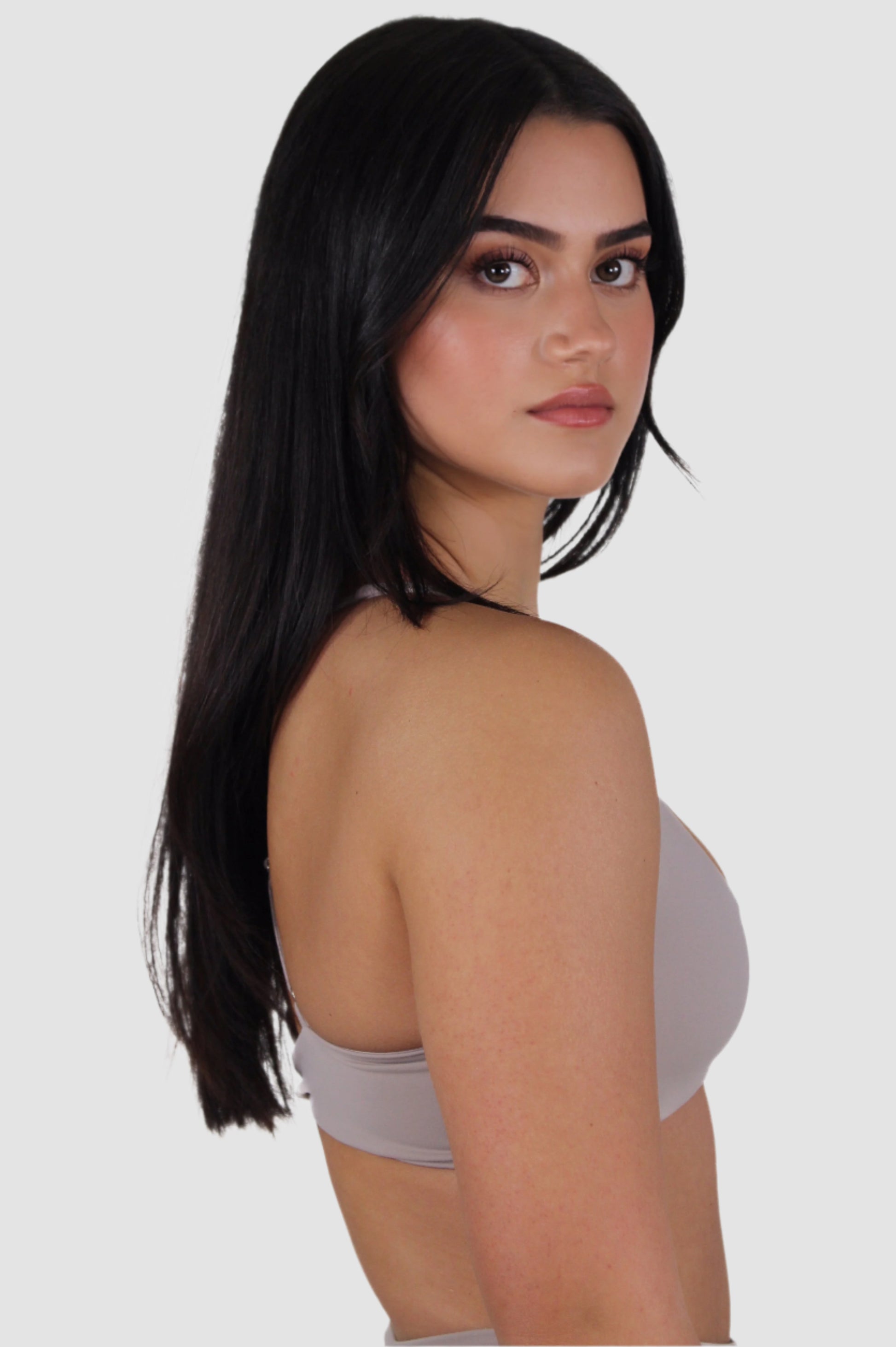 Side profile of light taupe Aivvia Athletics sports bra showing smooth, supportive fit.