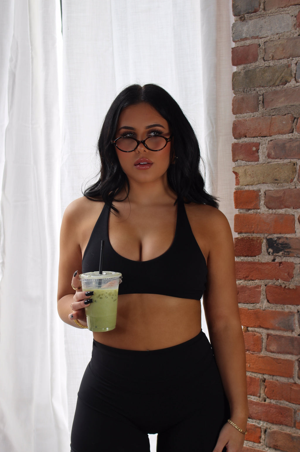 Woman in black Athletics leggings; modern, versatile activewear for gym, pilates, and everyday comfort.