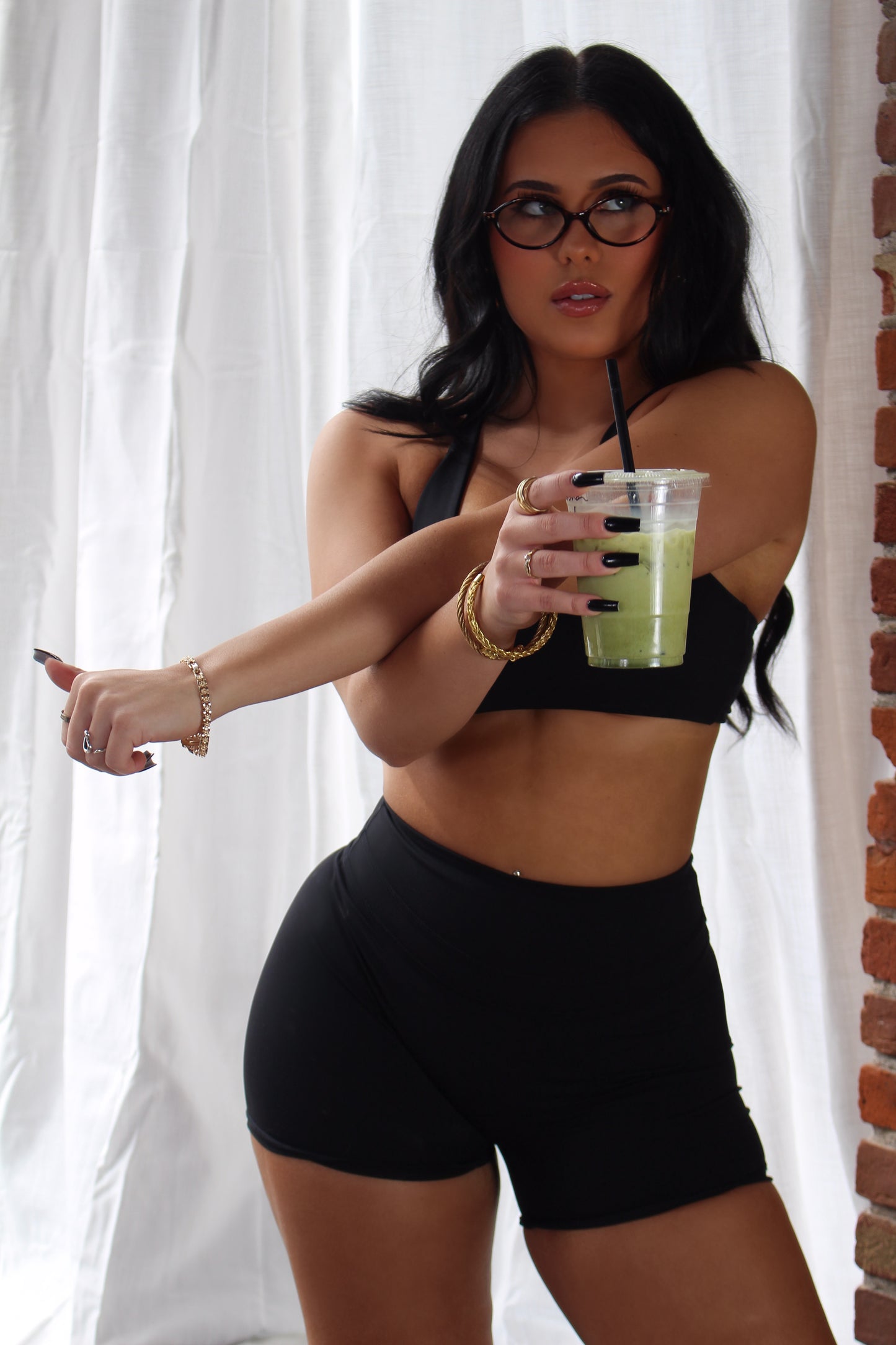 Woman in black Aivvia Athletics high-waisted shorts; sleek, supportive fit for training, yoga, and everyday comfort.