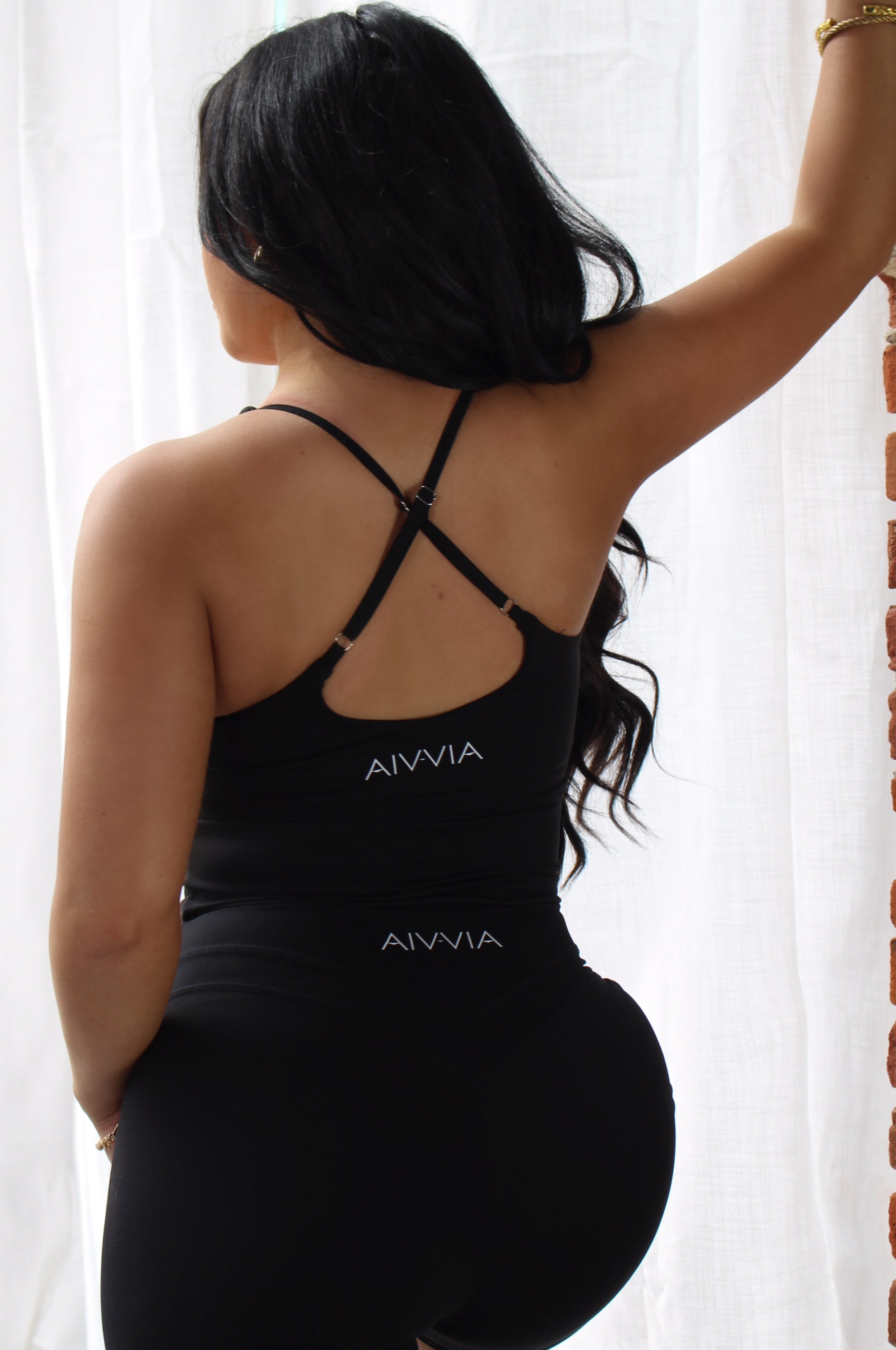 Side-back view of black Aivvia Athletics shorts; flexible, flattering design for active women.