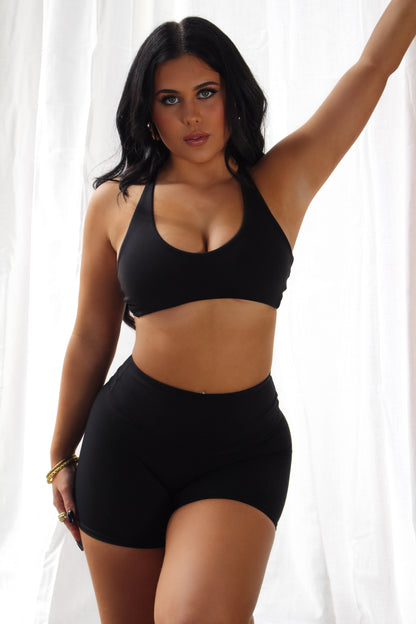 Woman in black Aivvia Athletics shorts; chic and functional activewear for gym, running, and casual wear.