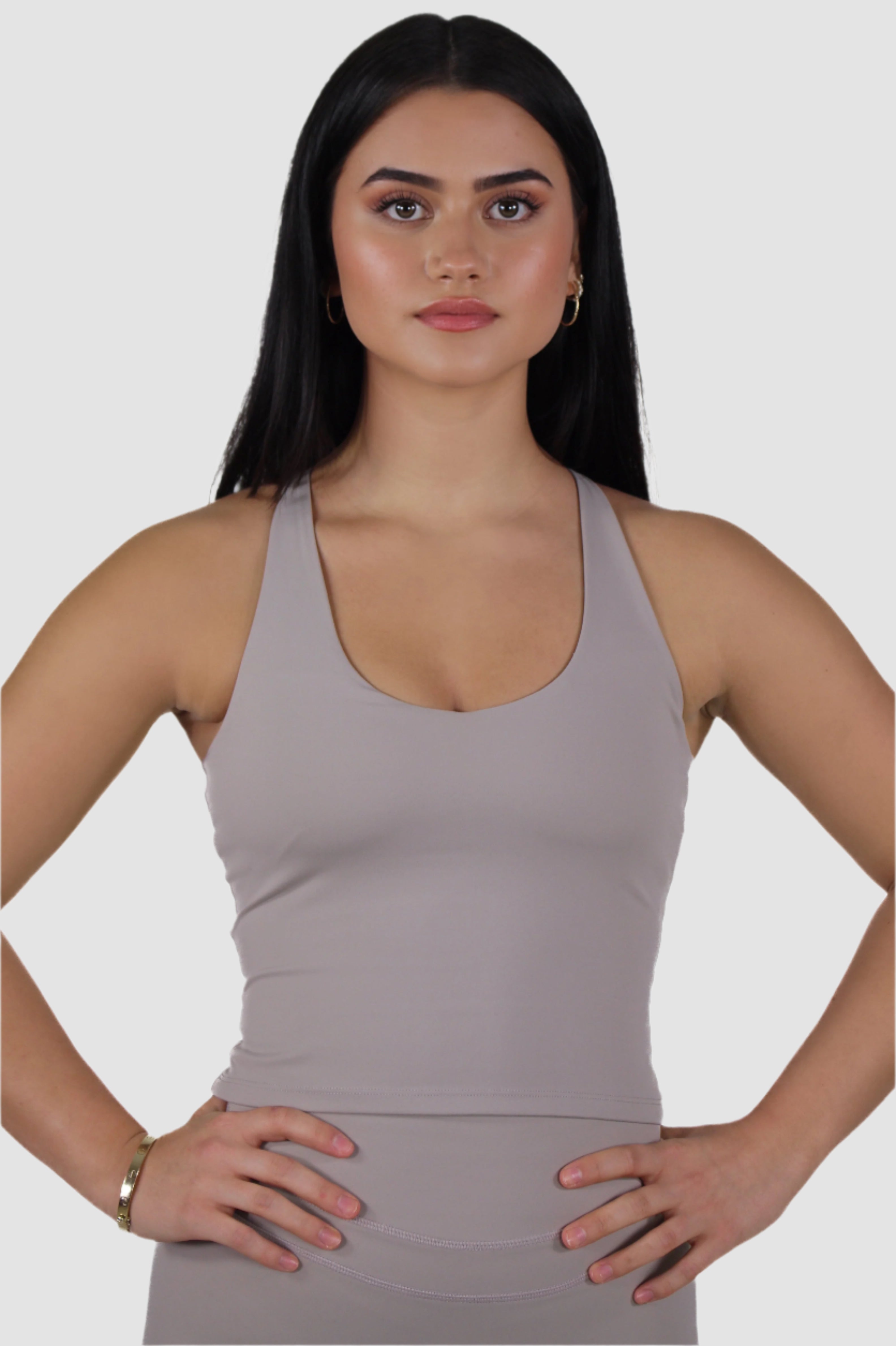 Front view of light taupe Aivvia Athletics fitted racerback tank top with scoop neckline.