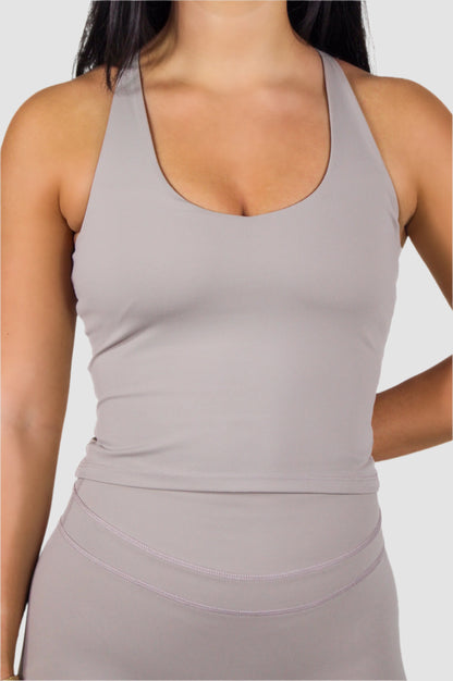Front-facing light taupe Aivvia Athletics racerback tank top paired with matching shorts.