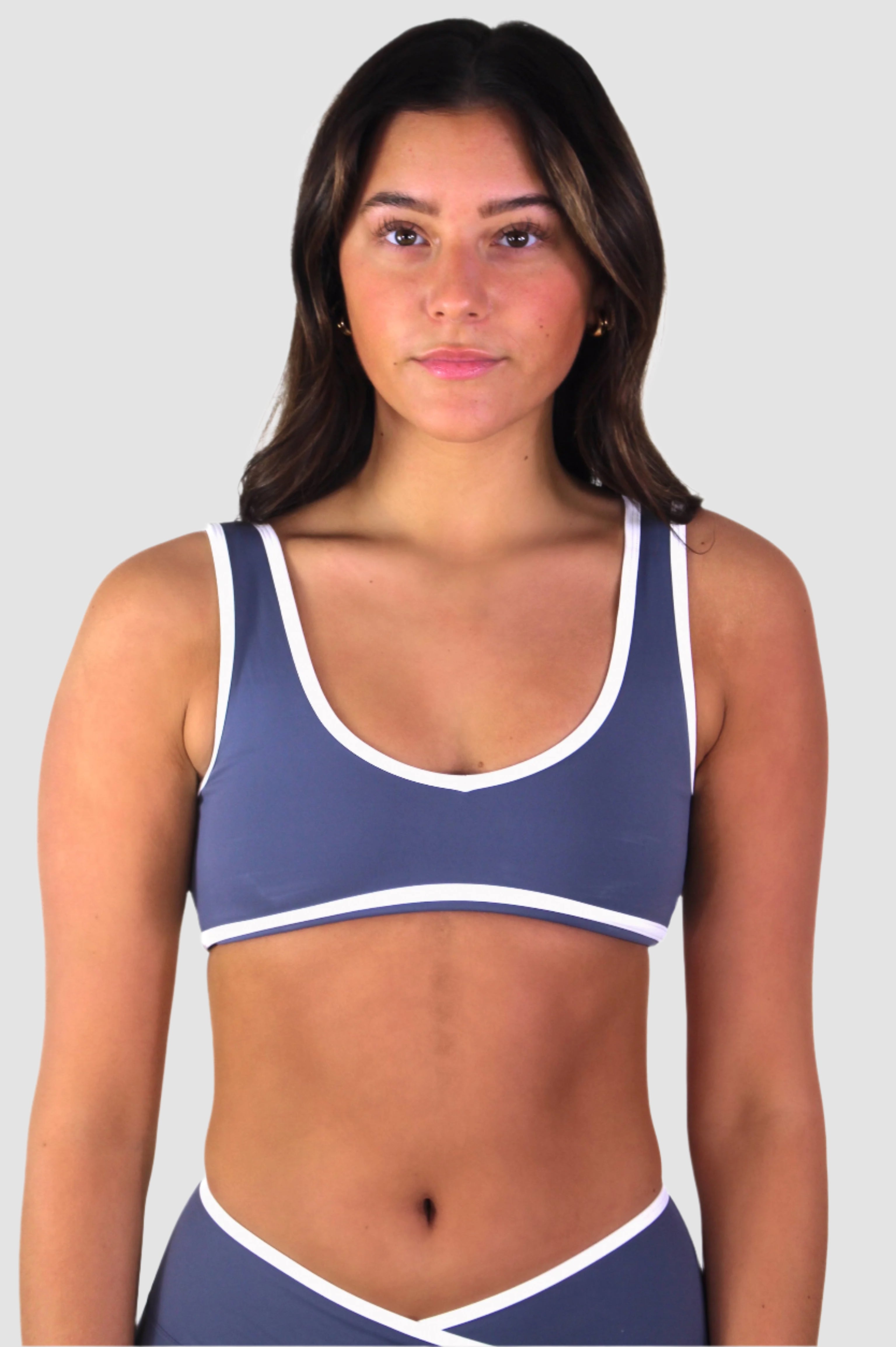 Front view of slate blue Aivvia Athletics sports bra, medium-impact support for yoga or Pilates.