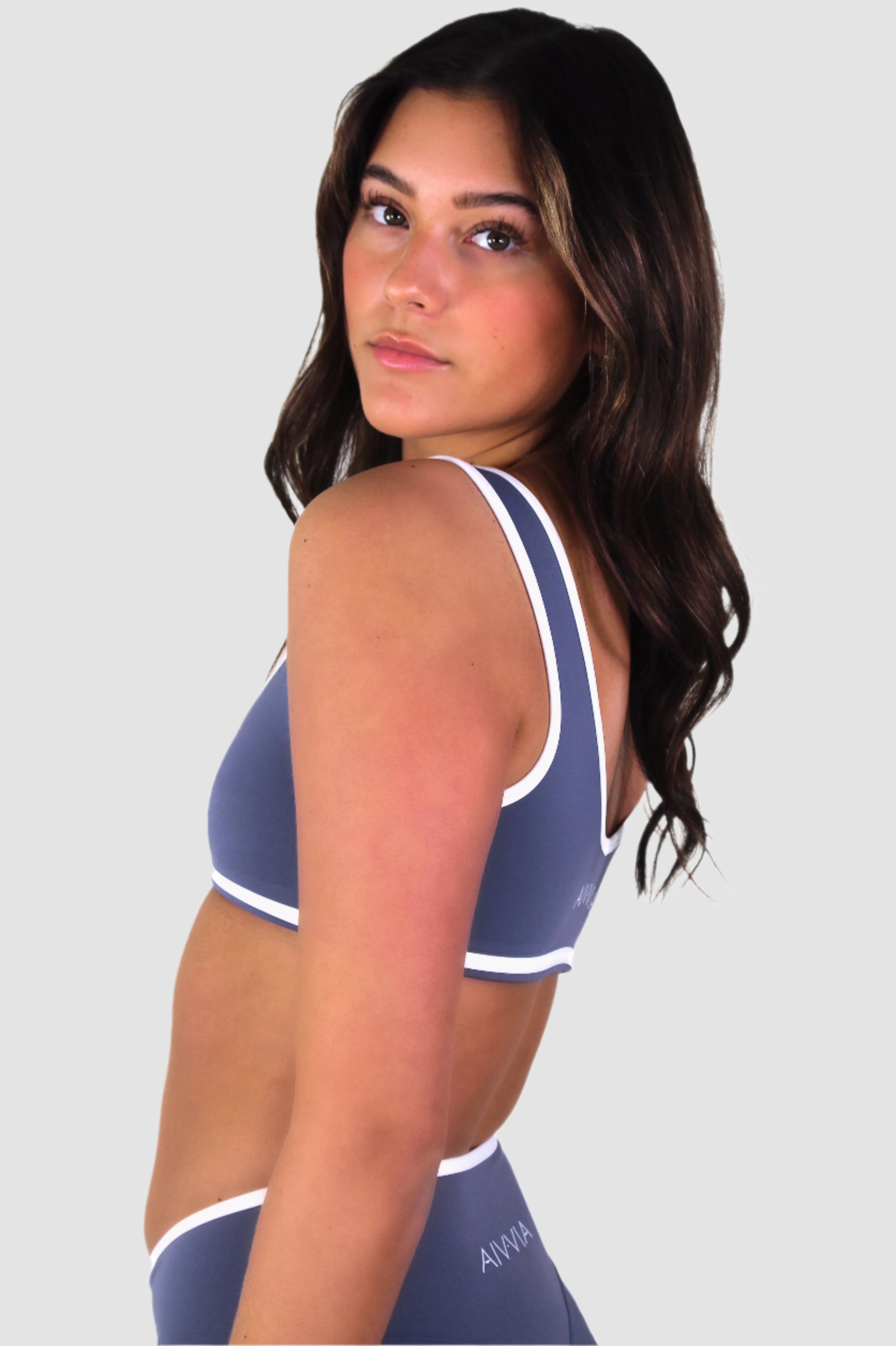 Side view of slate blue Aivvia Athletics sports bra, eco-friendly fabric with supportive fit.