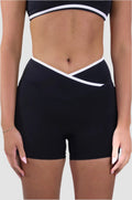 Front view of Aivvia Athletics black women’s athletic shorts with white trim and crossover waistband, sculpting inseam.