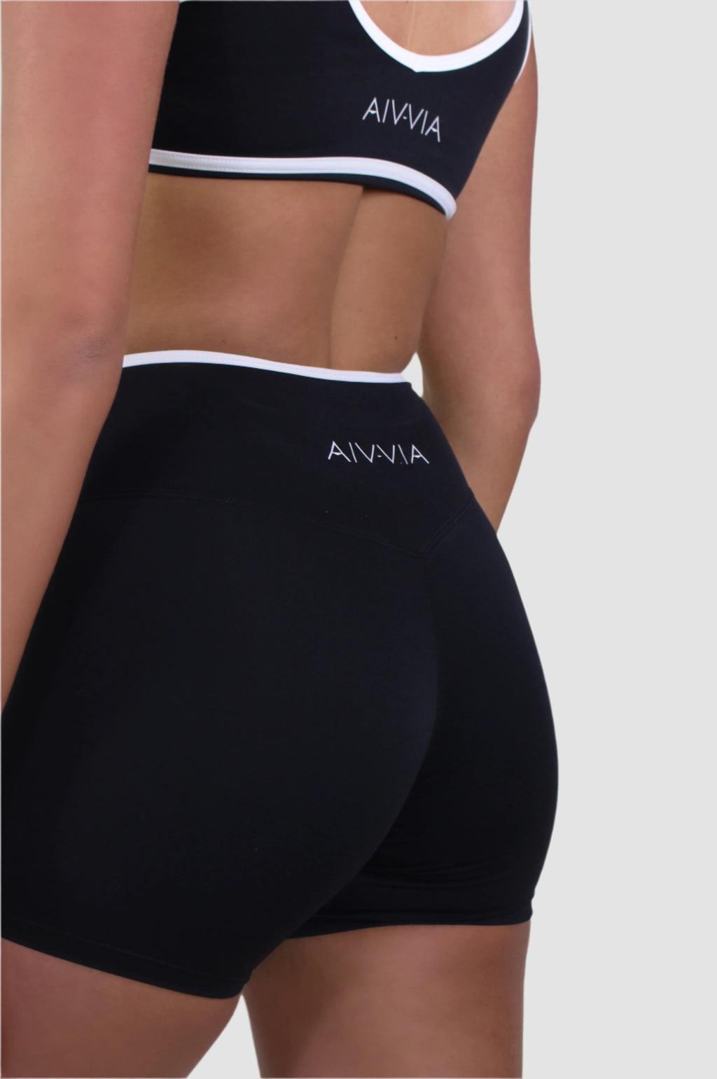 Back side view of Aivvia Athletics black crossover waistband shorts, ultra-soft second-skin fabric for active women.