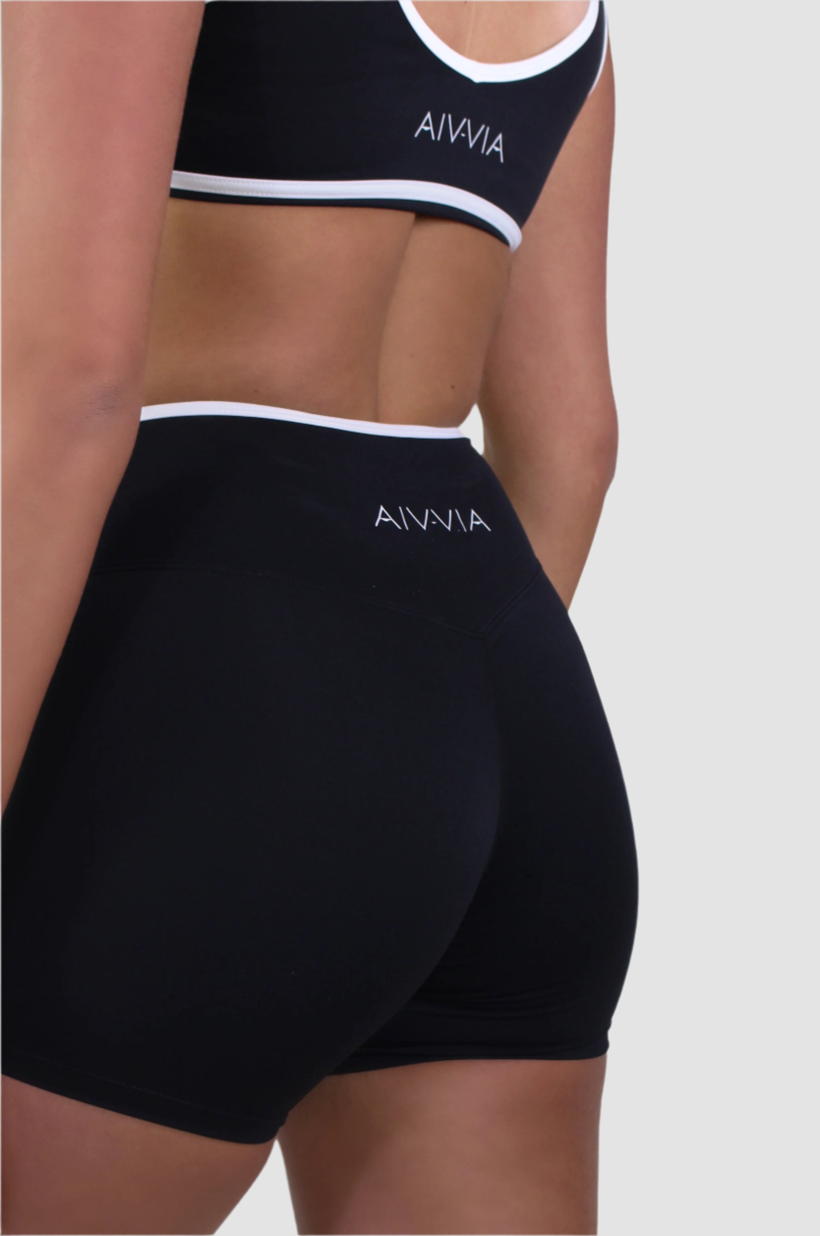Back side view of Aivvia Athletics black crossover waistband shorts, ultra-soft second-skin fabric for active women.