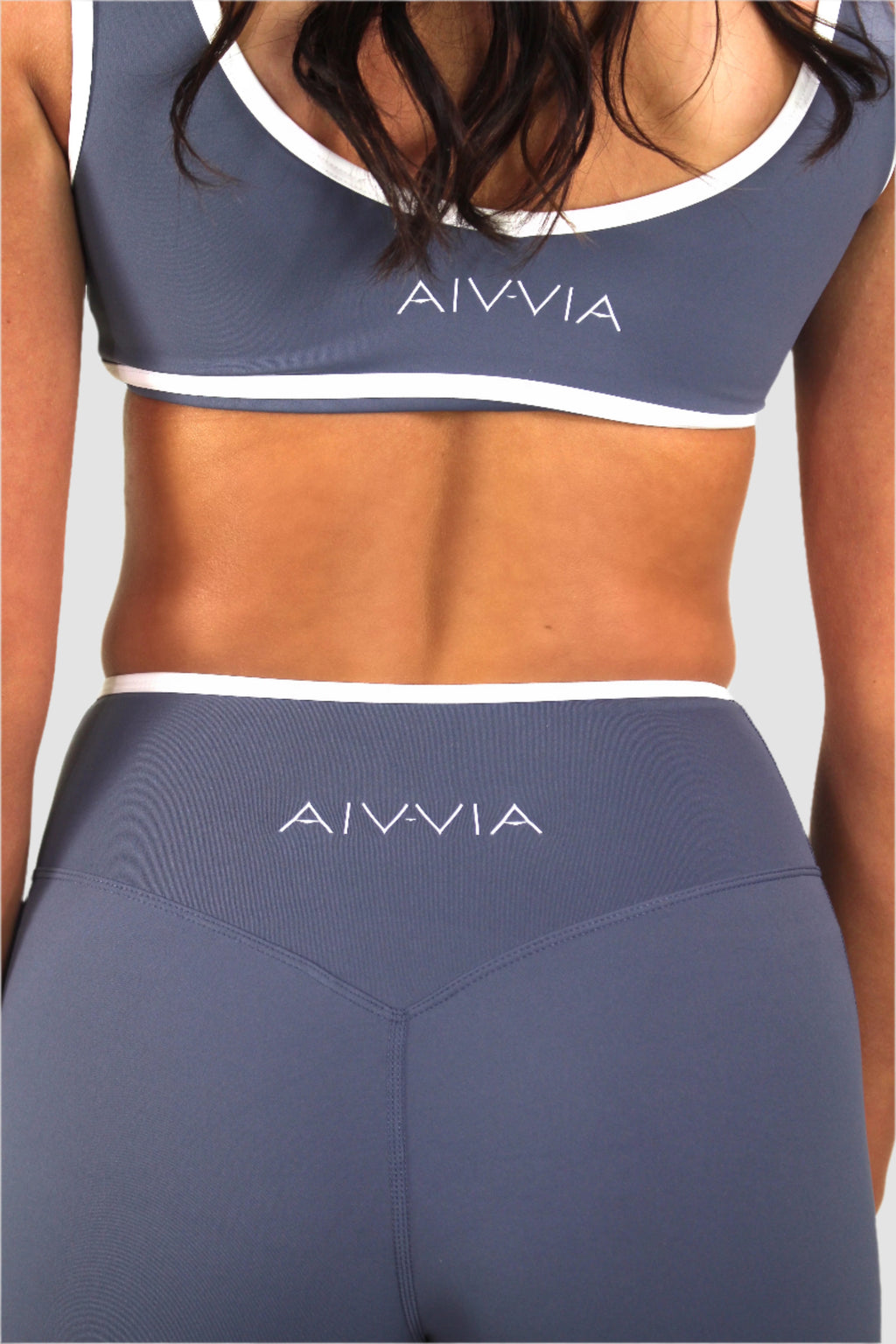 Back view of slate blue Aivvia Athletics crossover waistband shorts, breathable and lightweight for yoga or Pilates.