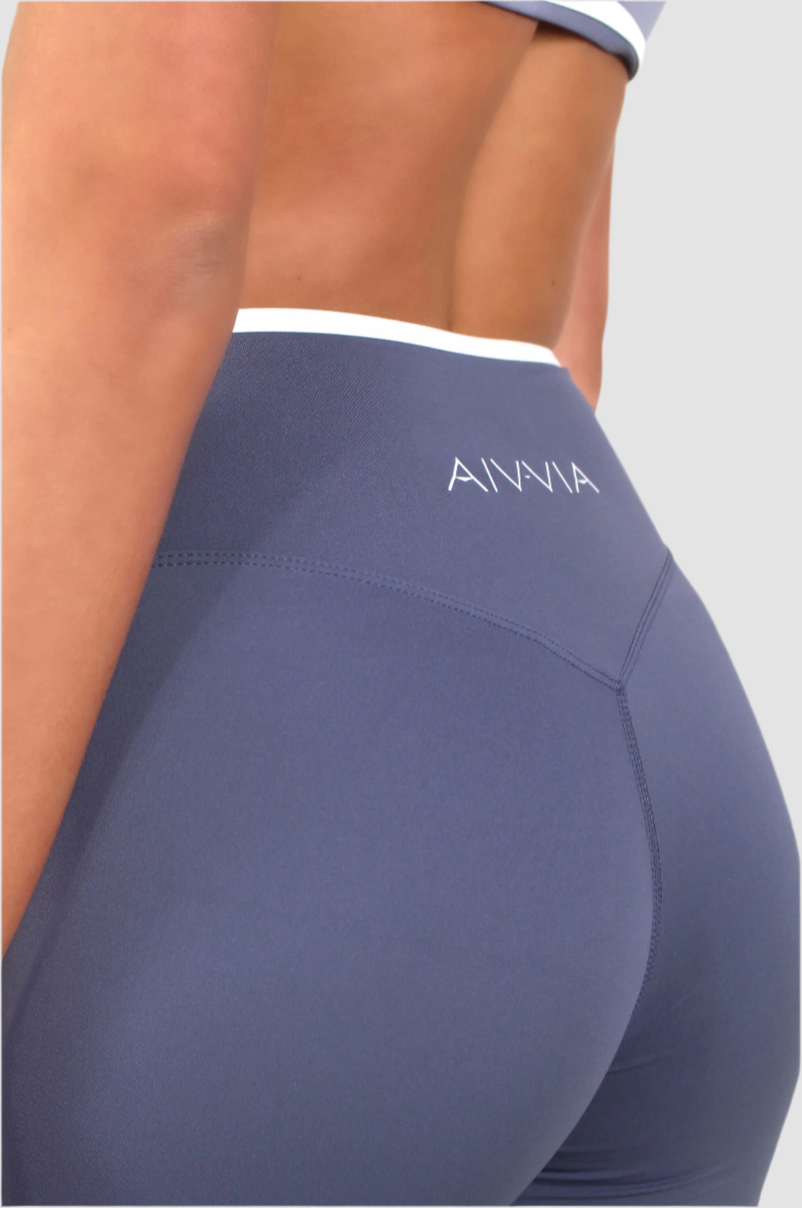 Close-up back detail of blue Aivvia Athletics athletic shorts, sculpting fit with eco-friendly performance fabric.