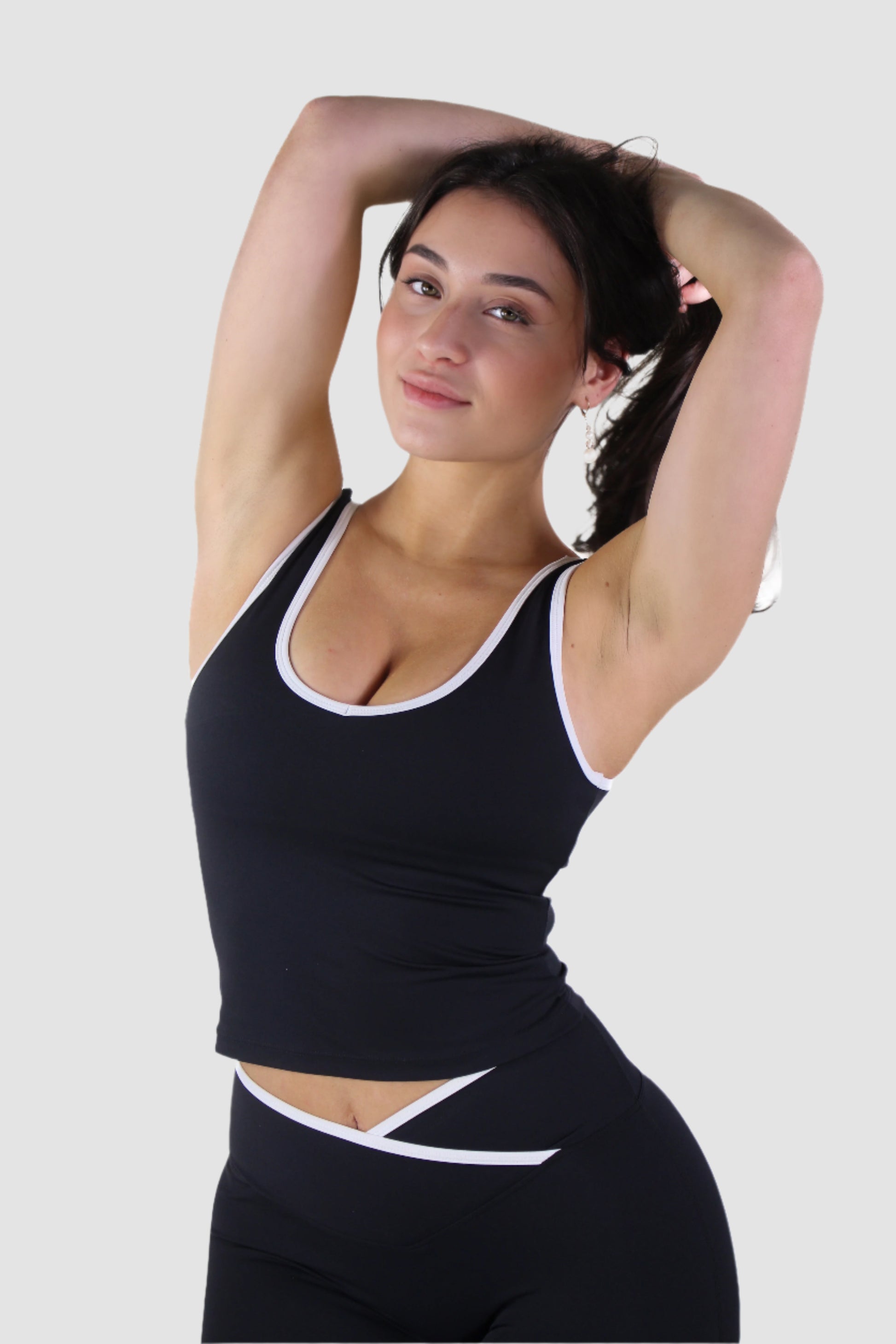 Side view of black Aivvia Athletics tank top, body-hugging fit with breathable athletic fabric.