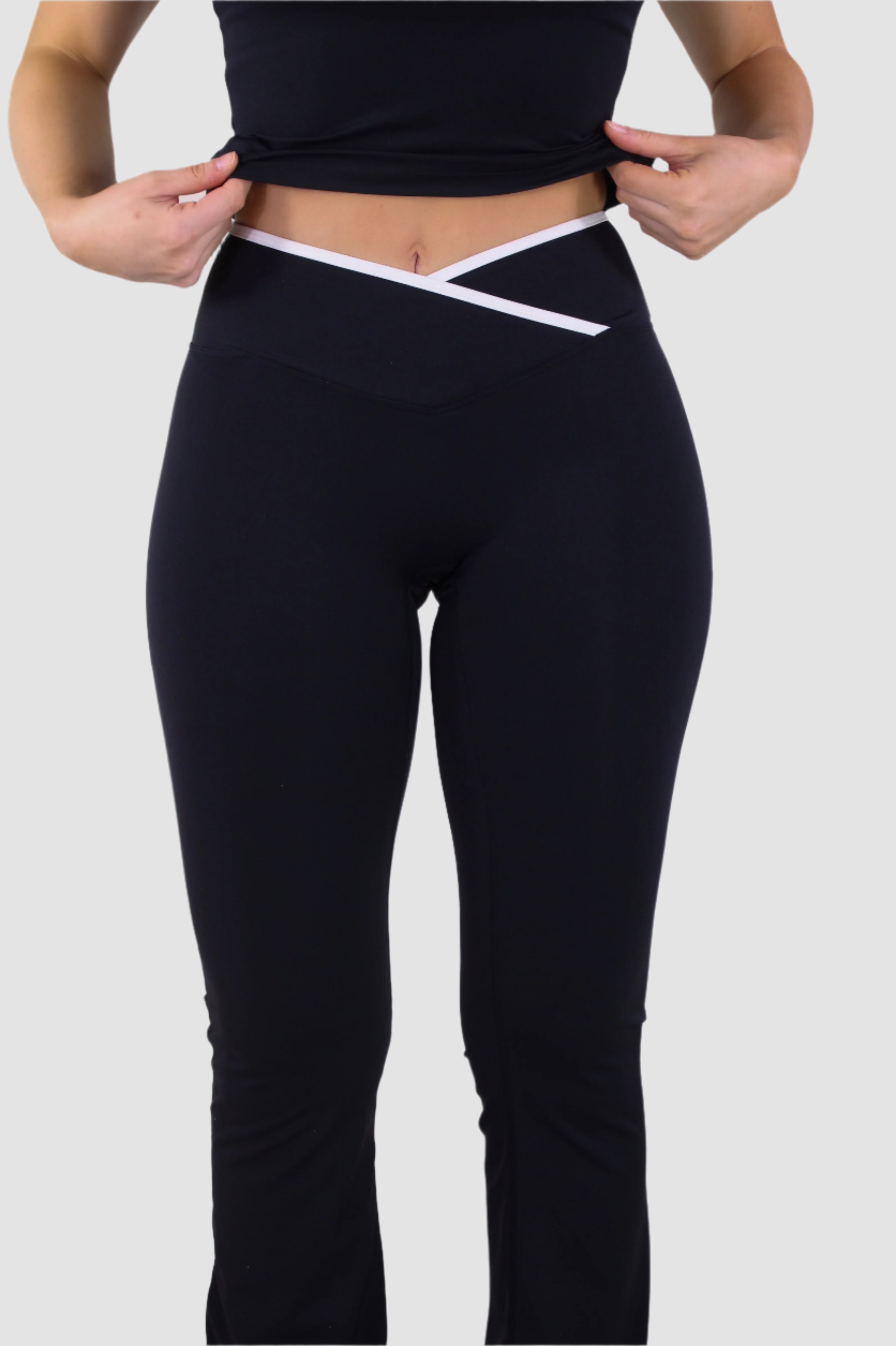 Front view of black Aivvia Athletics yoga pants, high-rise crossover waistband for flattering fit.