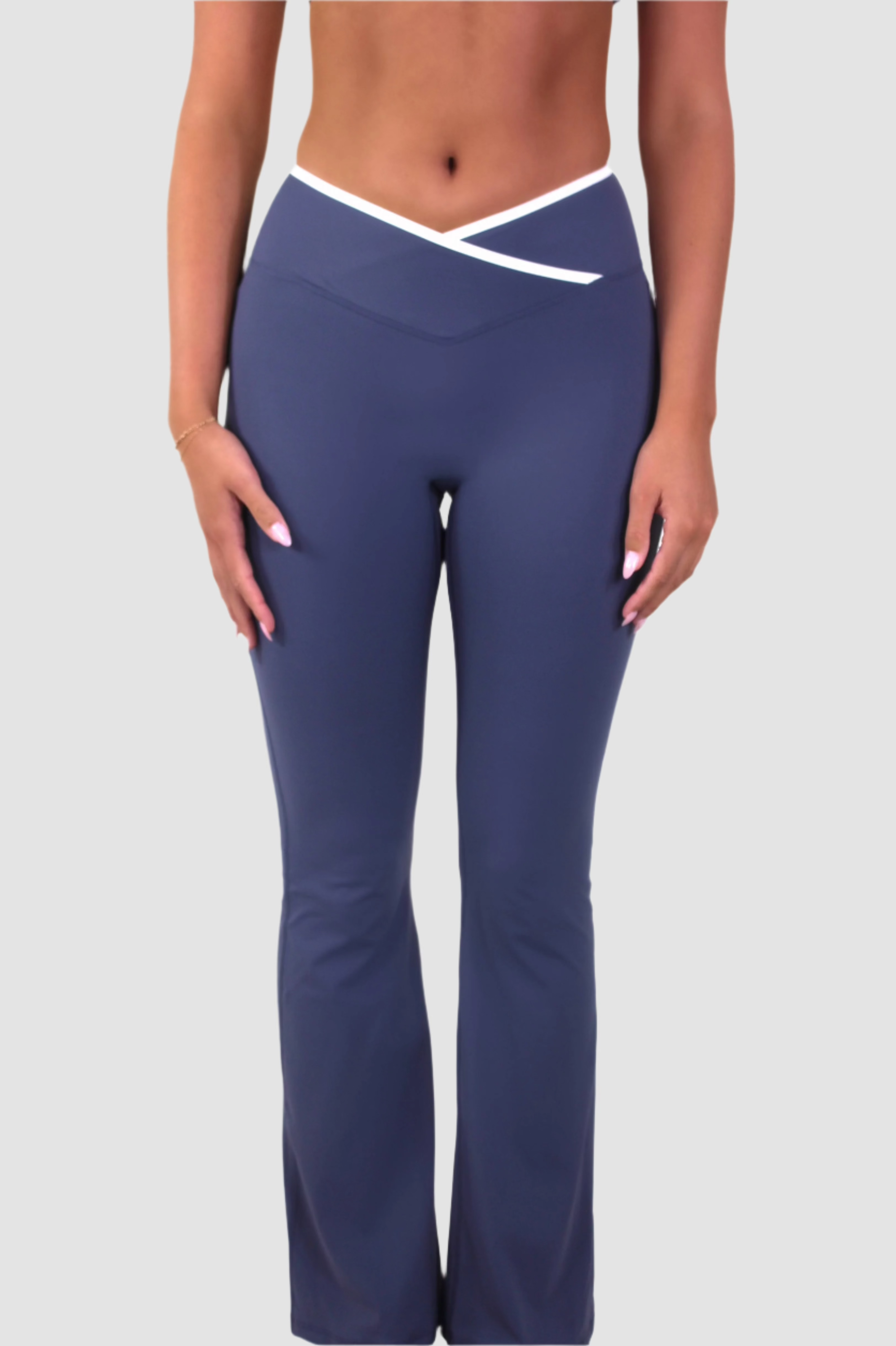 Front view of slate blue Aivvia Athletics women’s yoga pants with crossover waistband and flared leg.