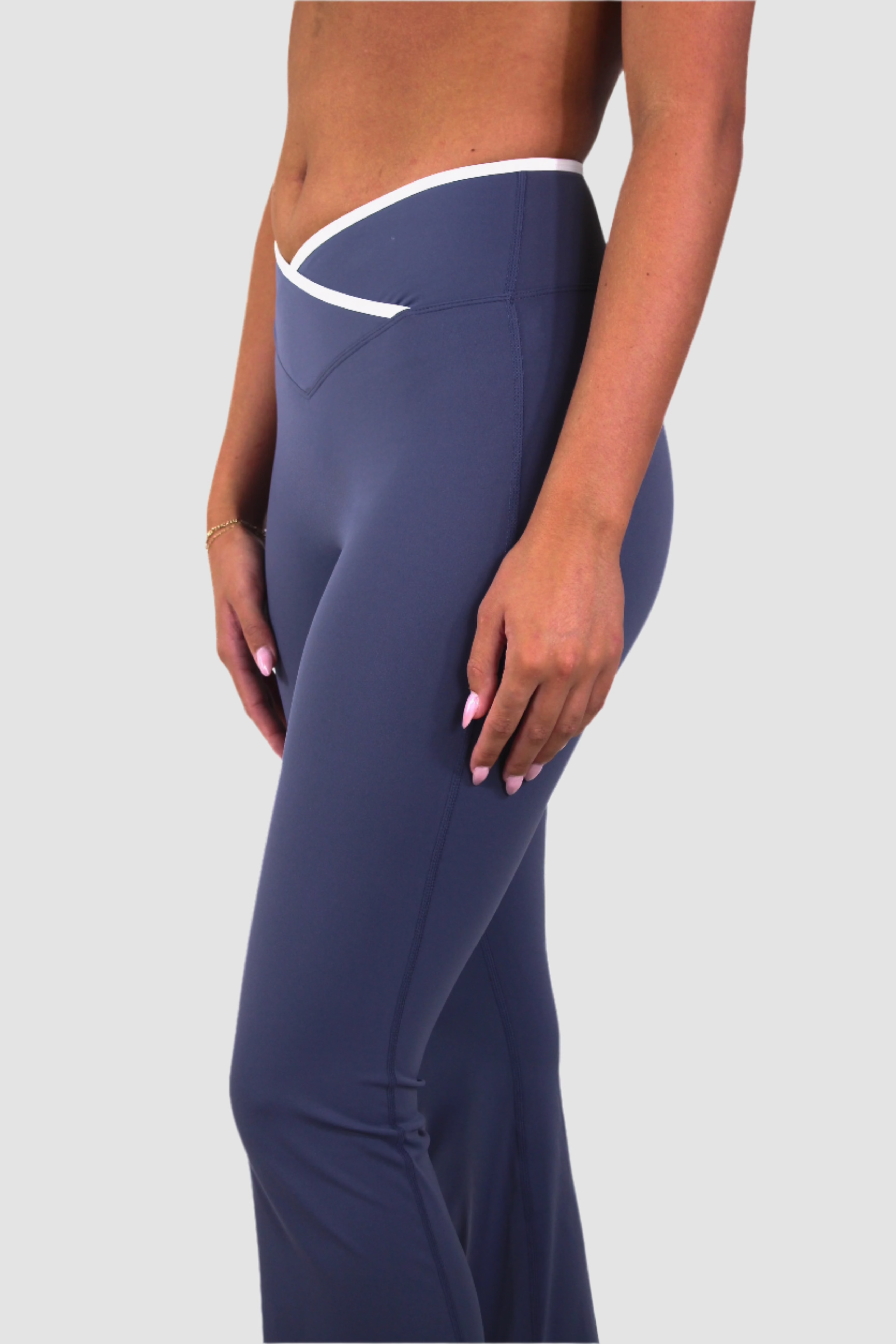 Side-back view of slate blue Aivvia Athletics yoga pants, lightweight fabric with flared leg.