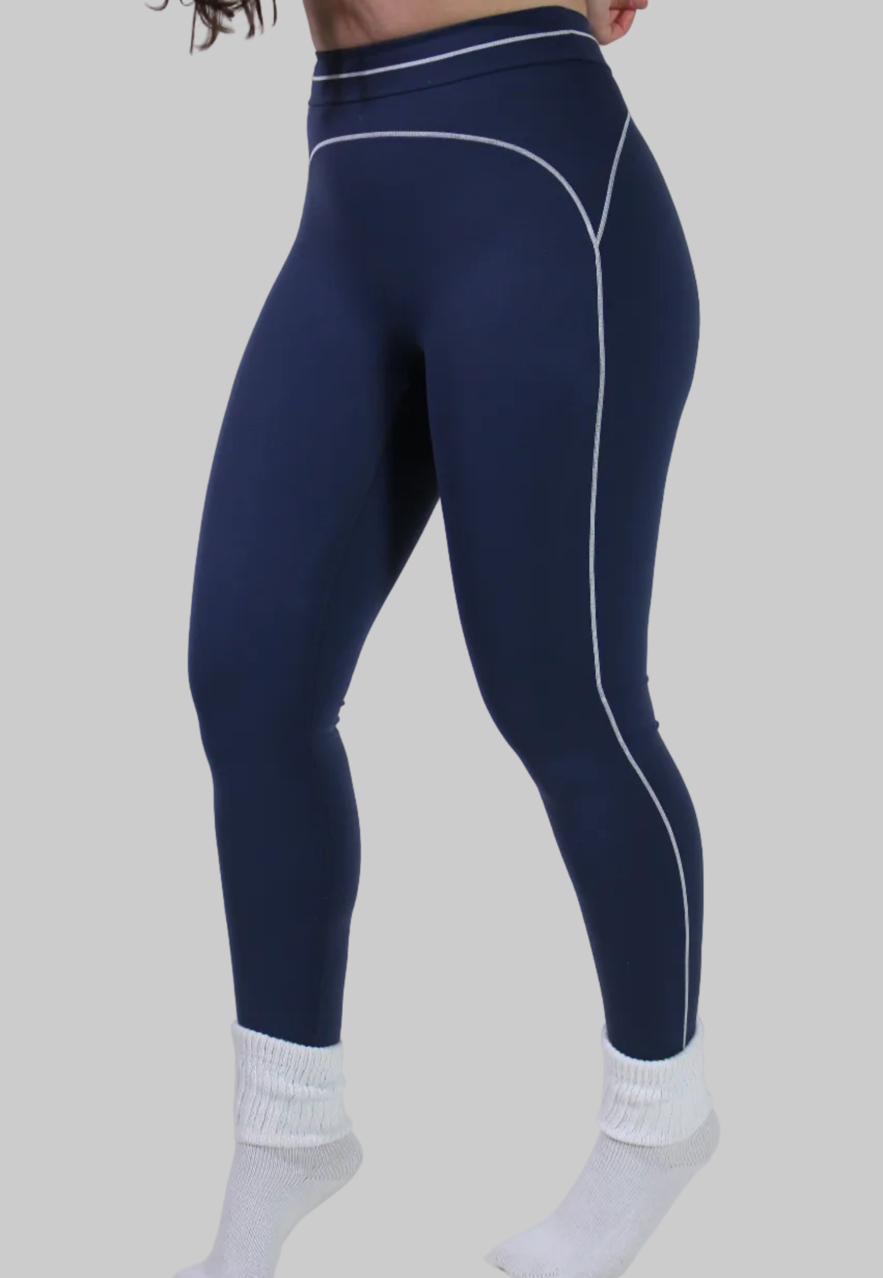 Navy leggings with white accents worn by a person on a light gray background