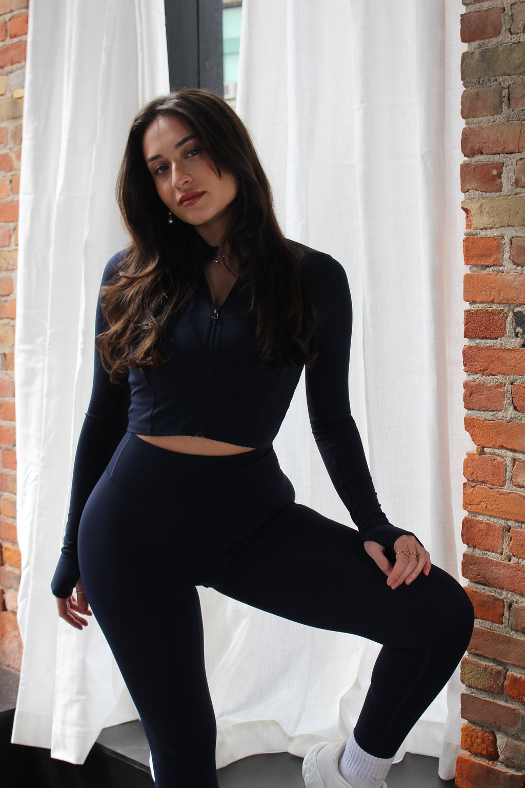 Navy Aivvia Athletics cropped zip-up jacket; sleek, form-fitting silhouette for gym or casual wear.