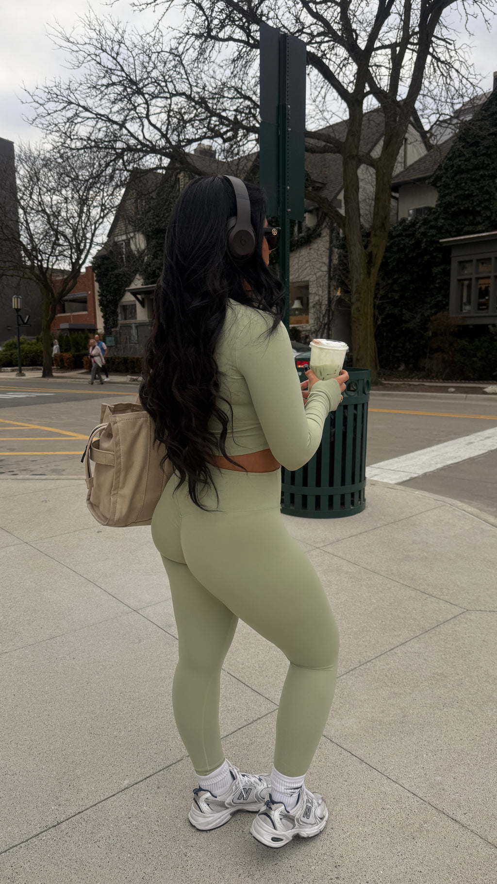 Outdoor candid of Aivvia Athletics sage green sports bra and leggings, stylish fitness set for active lifestyles.