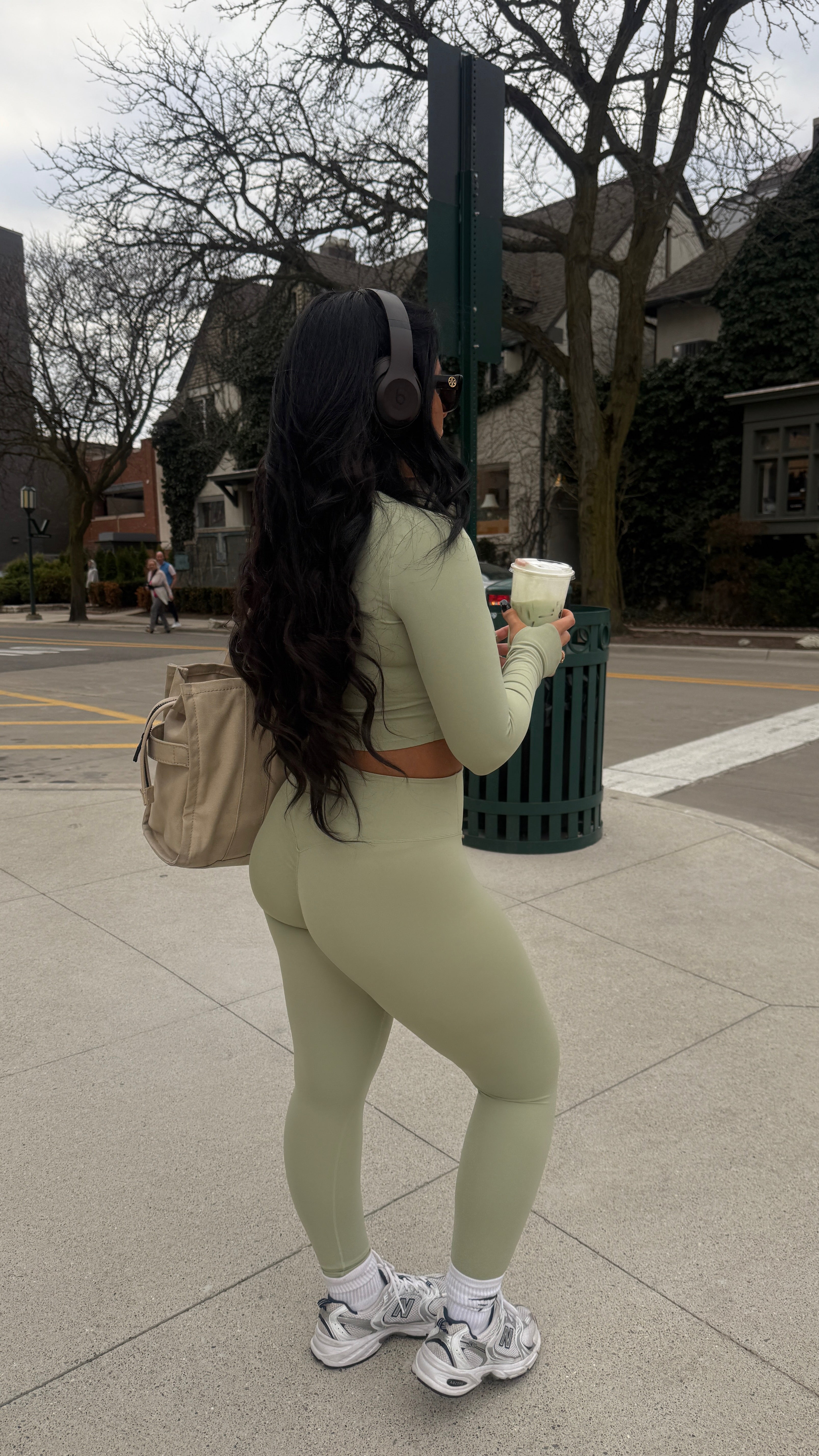 Outdoor candid of Aivvia Athletics sage green sports bra and leggings, stylish fitness set for active lifestyles.