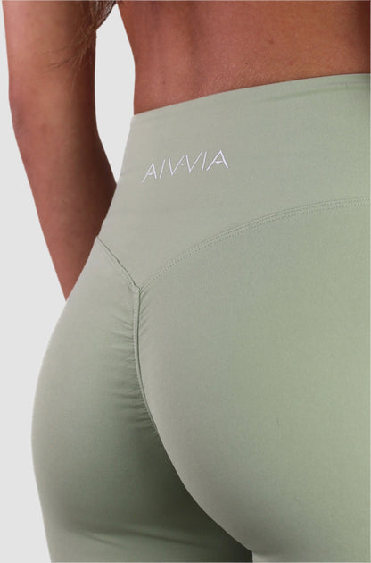 Close-up of sage green Aivvia Aesthetics leggings waistband, focusing on smooth seams and compression support.