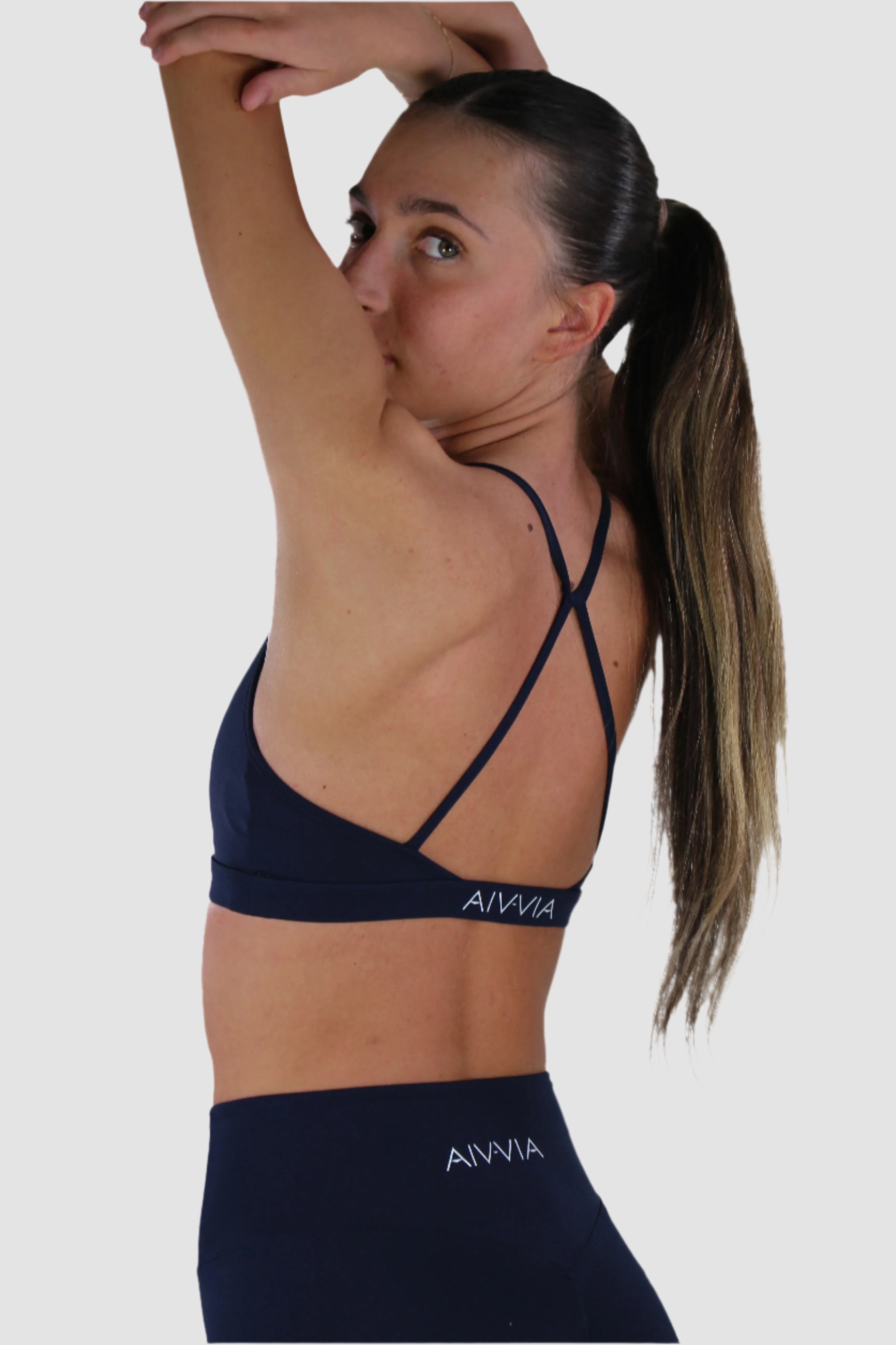 Navy Aivvia Athletics sports bra featuring cross-back straps and supportive fit.