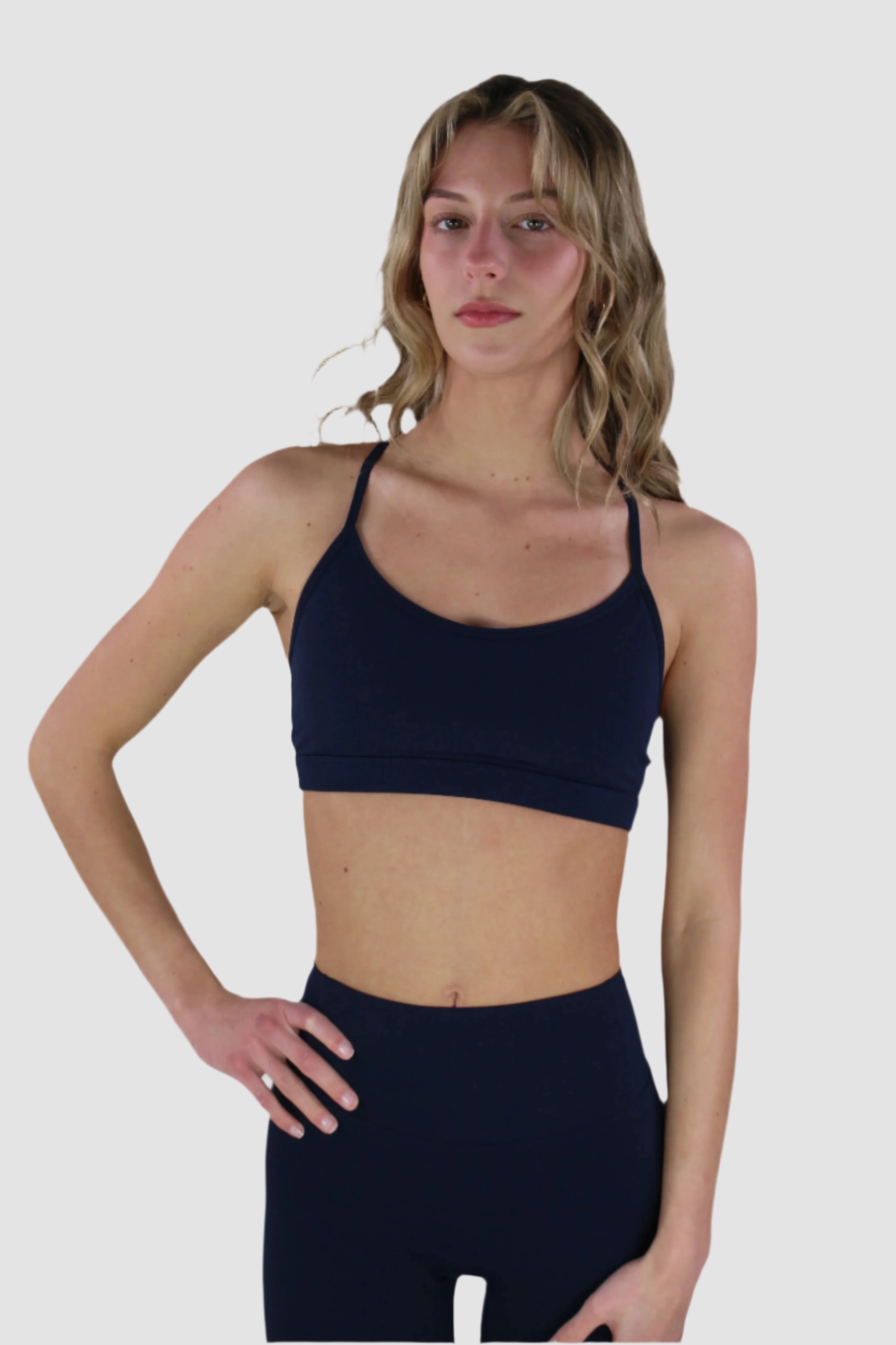 Navy Aivvia Athletics sports bra with minimal design and smooth finish, styled for activewear.