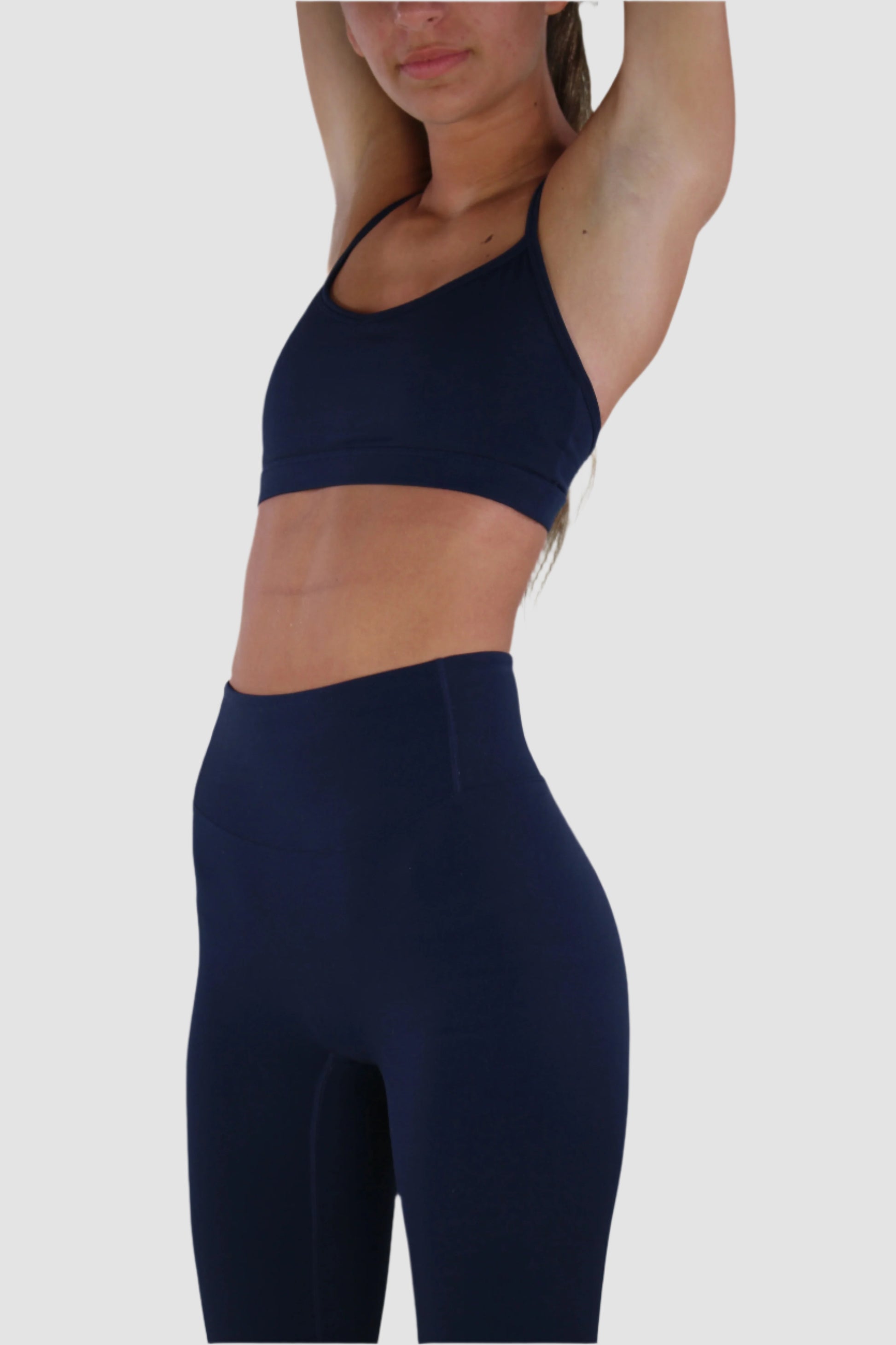 Side view of navy Aivvia Athletics sports bra highlighting athletic contour and sleek fit.