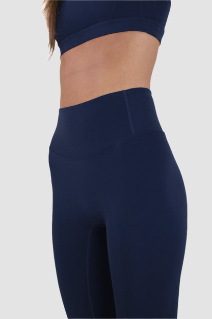 Side view of navy Aivvia Athletics leggings highlighting smooth compression fit and ankle length.
