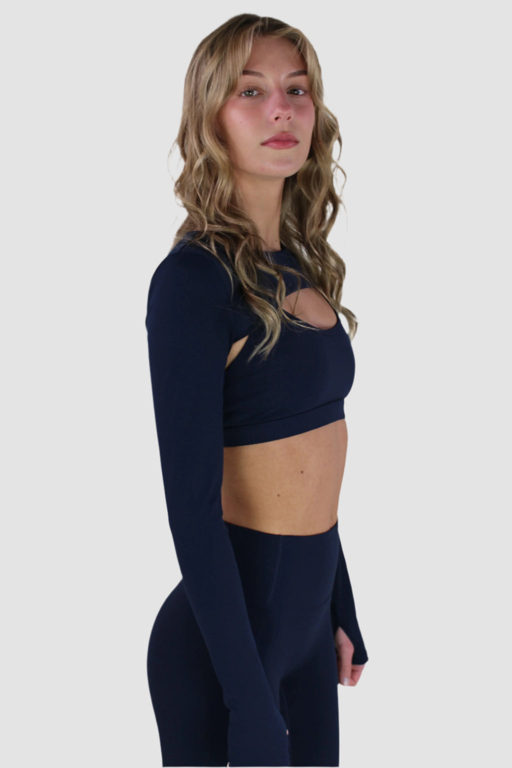 Navy Aivvia Athletics long-sleeve shrug showing smooth, stretchy fabric and athletic fit.