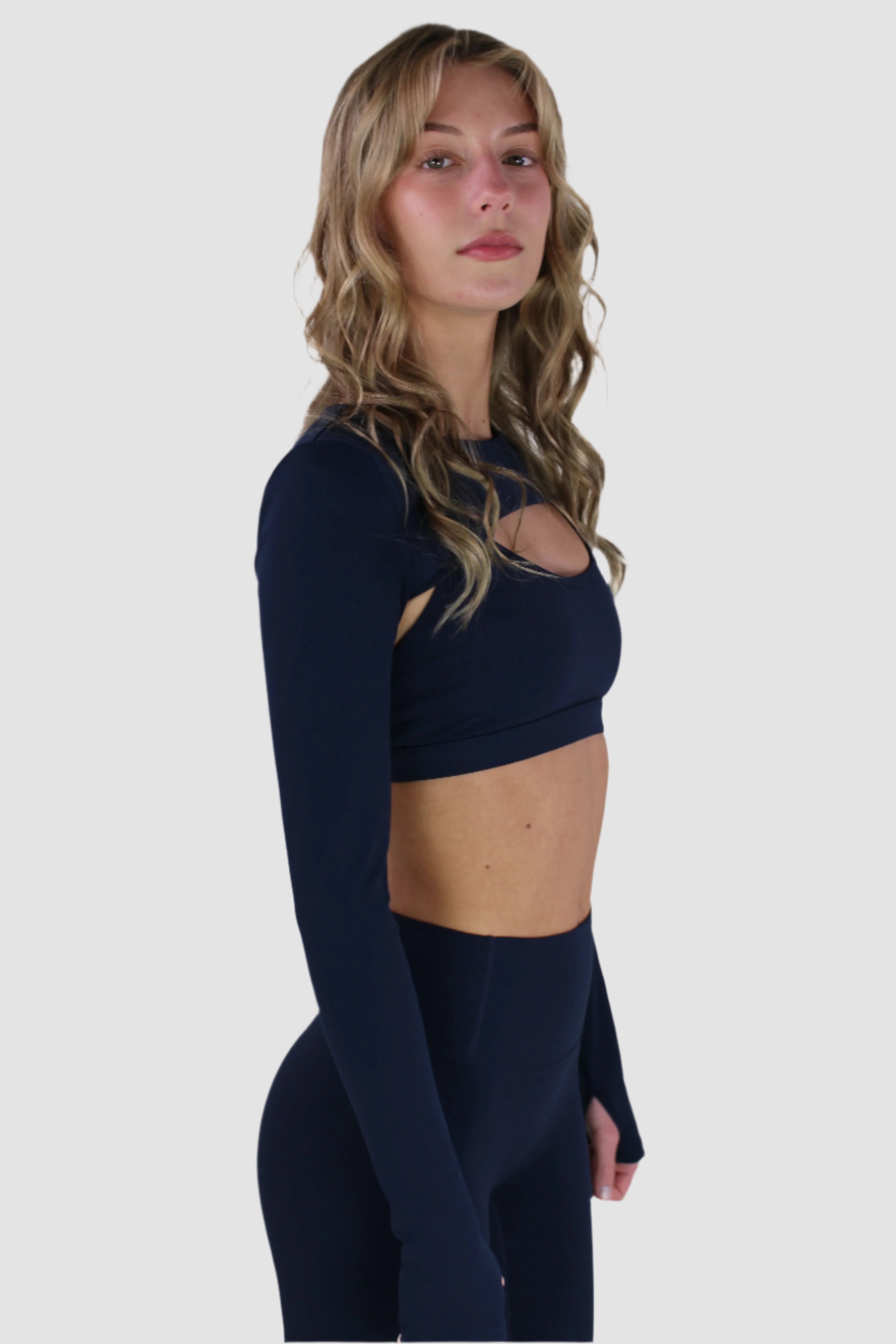 Navy Aivvia Athletics long-sleeve shrug showing smooth, stretchy fabric and athletic fit.