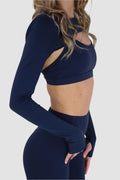 Side view of navy Aivvia Athletics cropped shrug with cutout front and contoured sleeves.