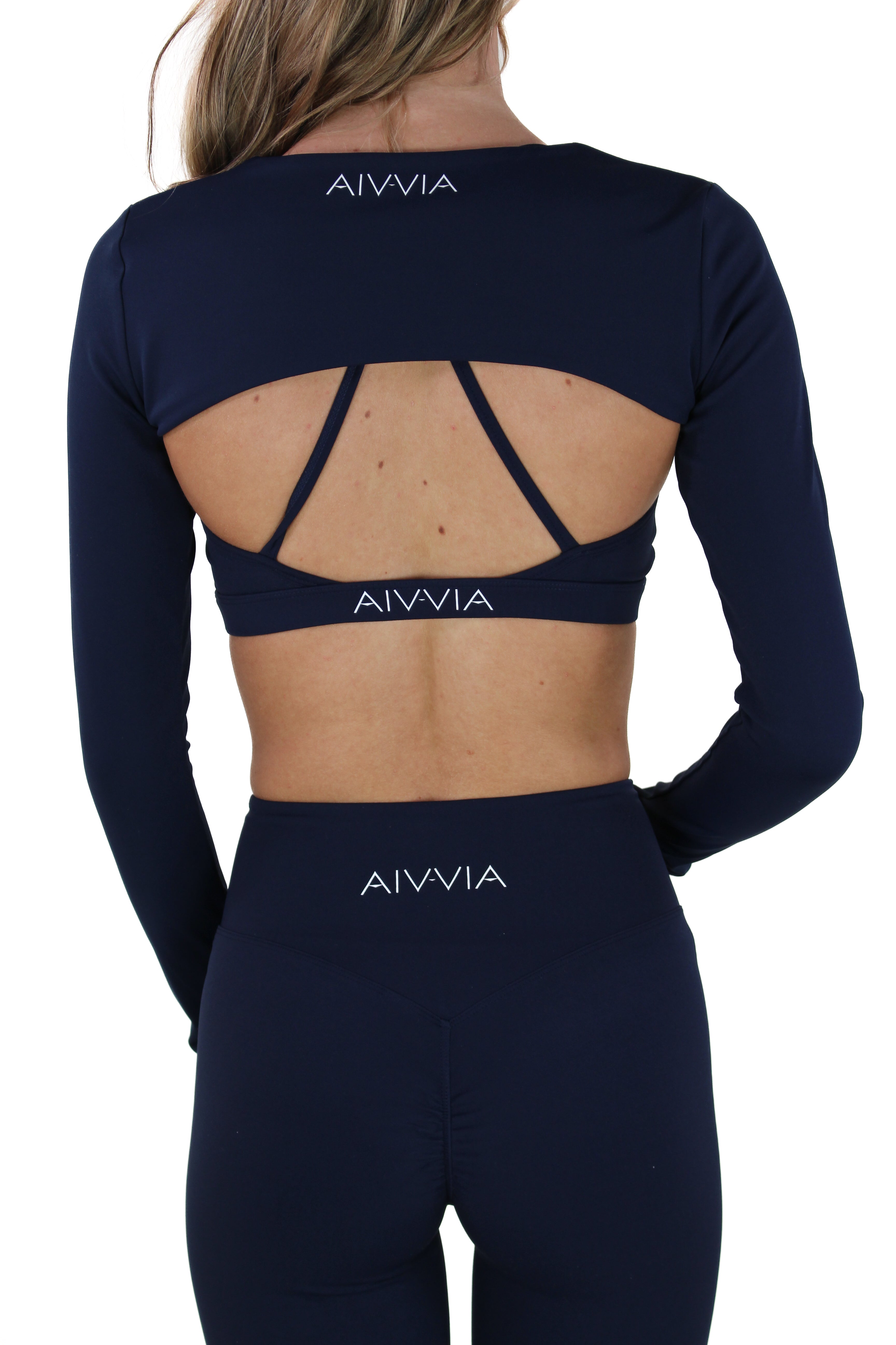 Full back view of navy Aivvia Athletics shrug with wide back cutout and logo detail.

