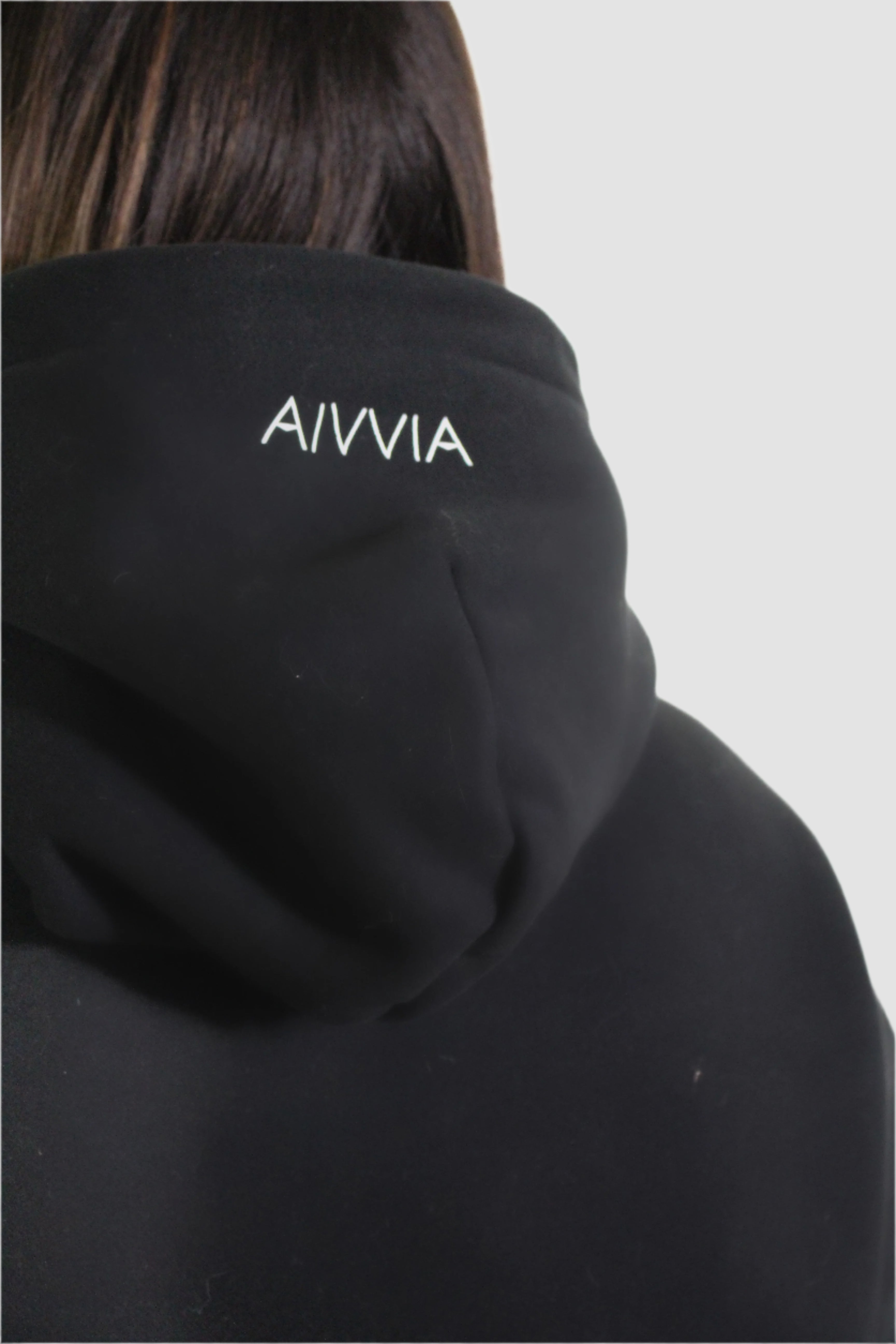 Close-up hood detail of black Aivvia Athletics hoodie with embroidered logo.