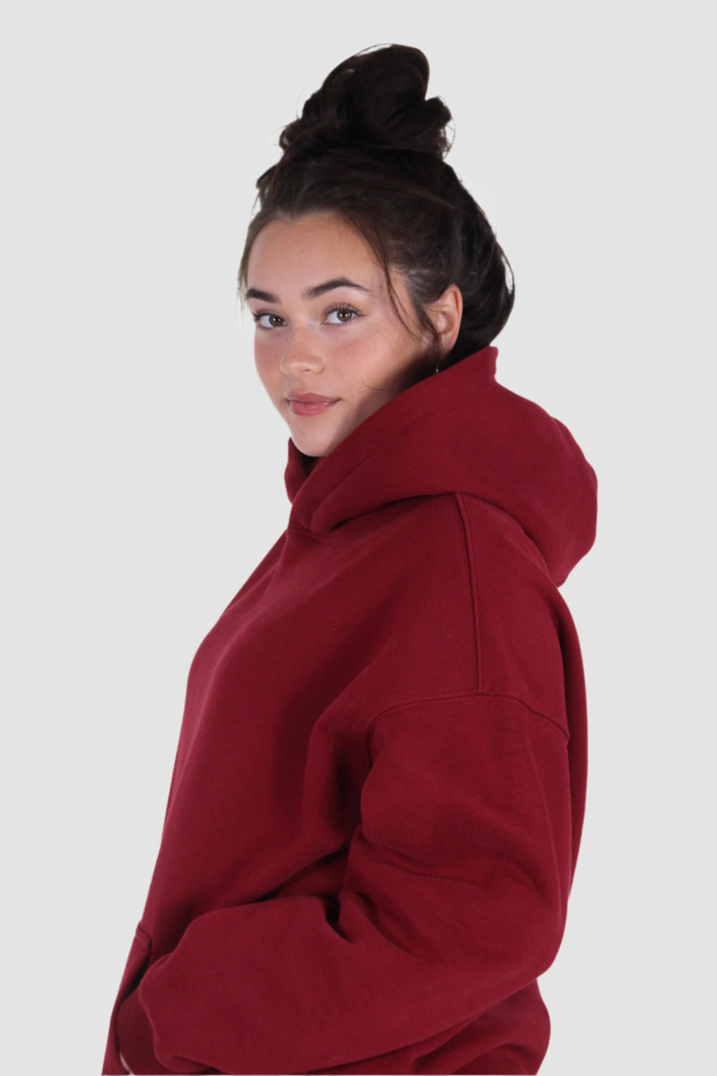 Side view of Aivvia Athletics red hoodie, stylish women’s activewear top with drawstring hood.