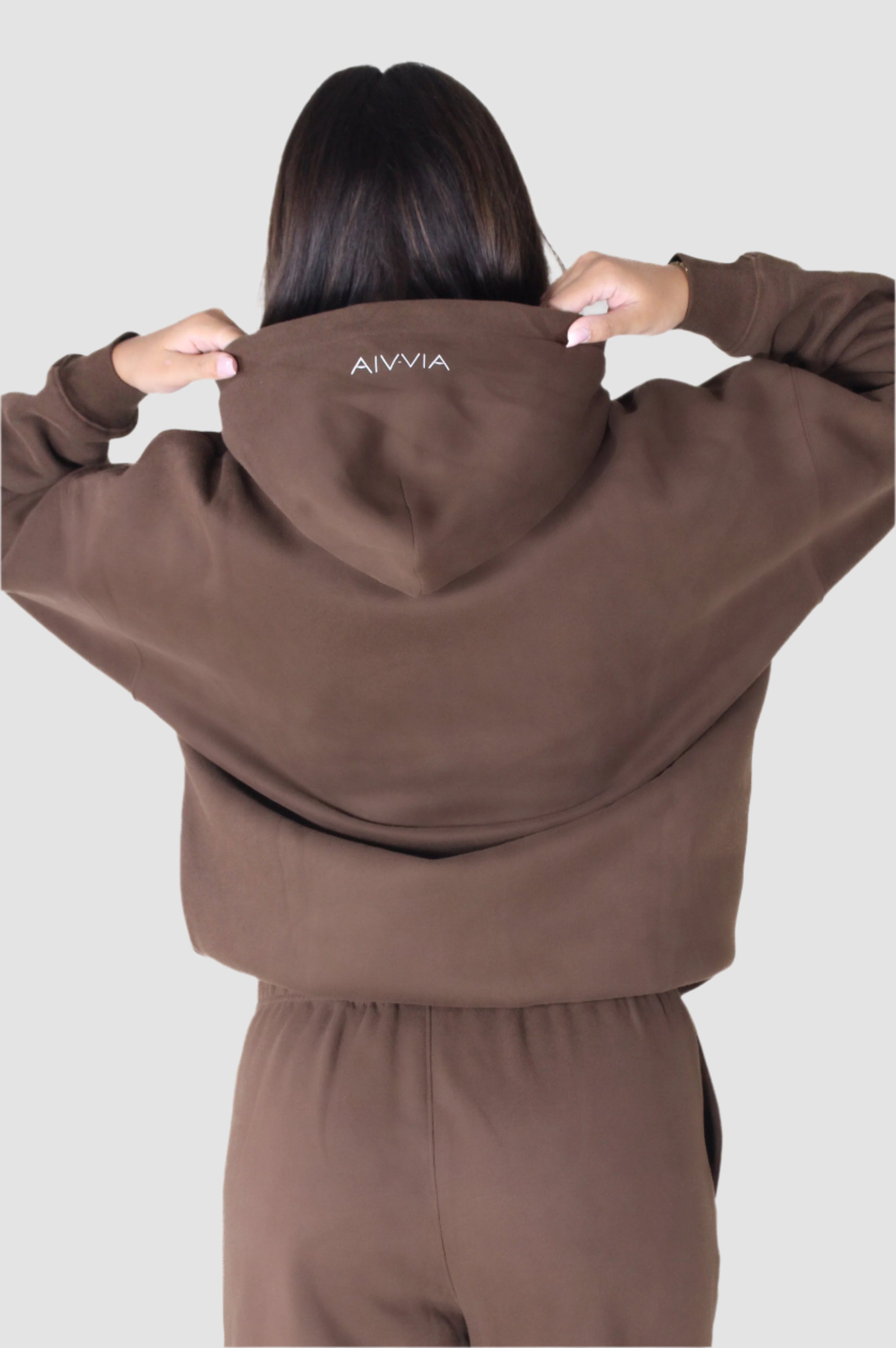 Back view of brown Aivvia Athletics hoodie, relaxed fit women’s activewear with minimalist athletic design.