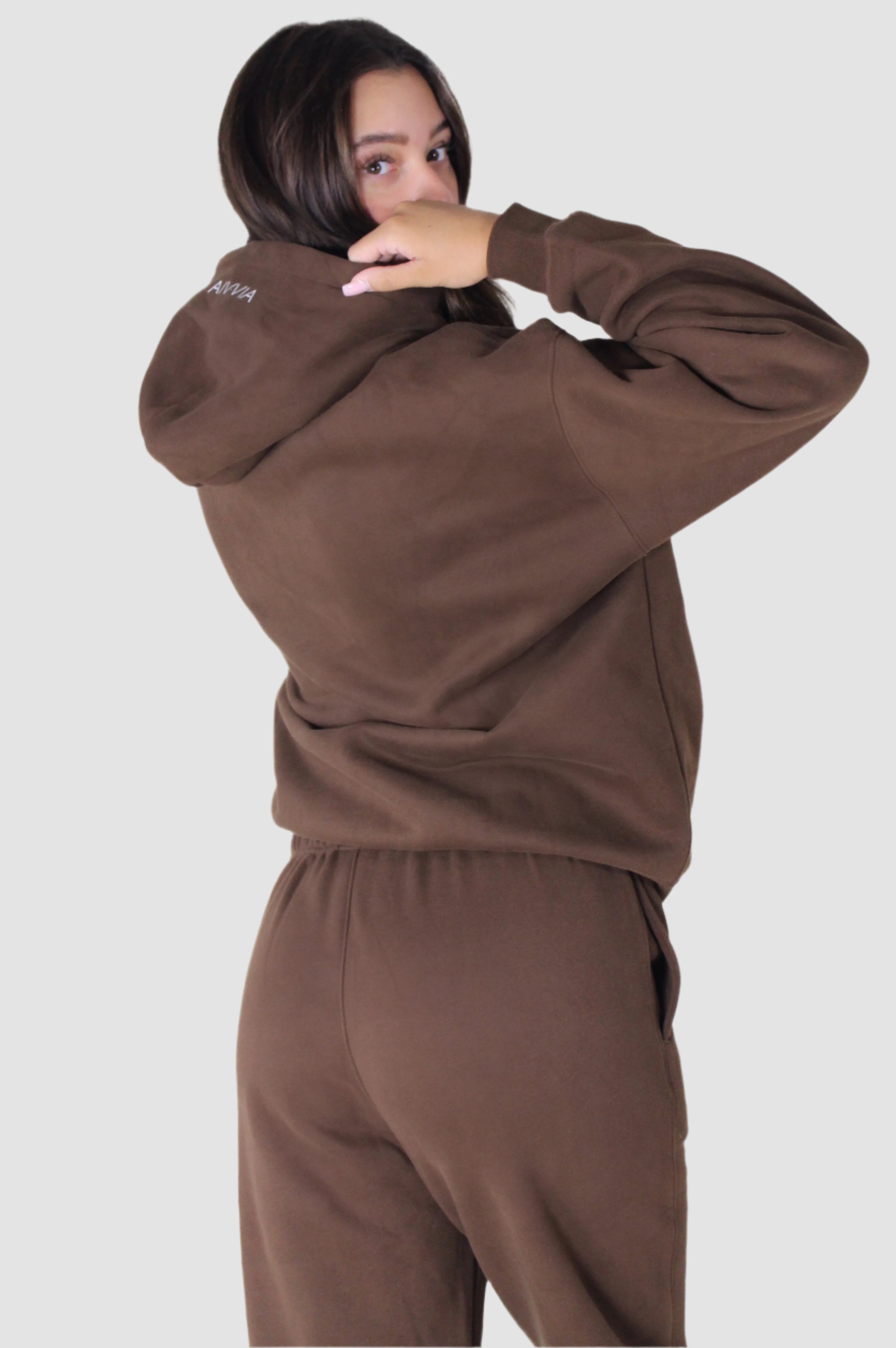 Side profile of brown Aivvia Athletics hoodie, warm women’s athletic pullover for comfort and performance.