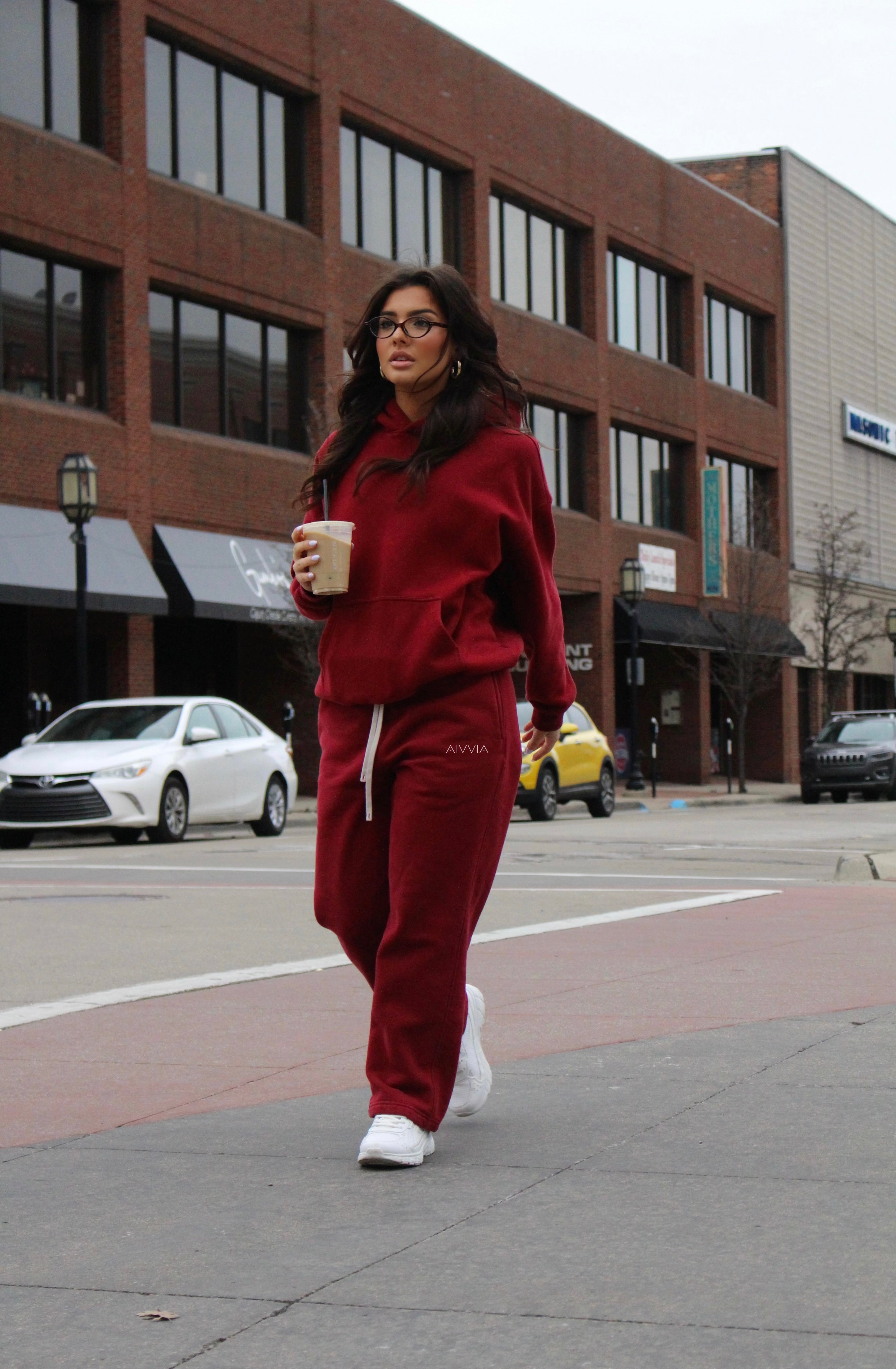 Aivvia Athletics burgundy sweatpants in motion, sporty streetwear style for women, cozy and athletic.