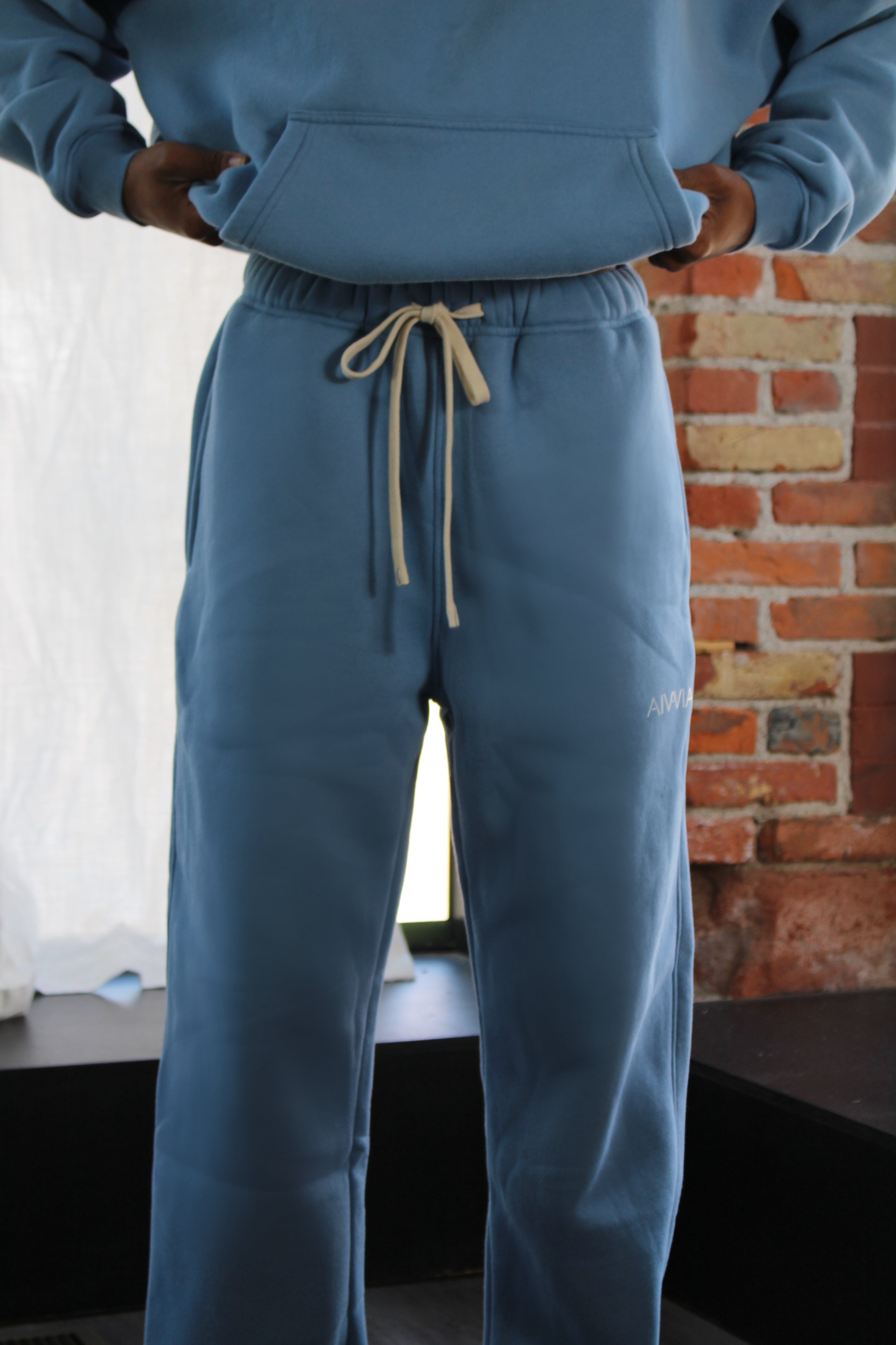 Classic light blue Aivvia Athletics sweatpants with jogger silhouette and adjustable drawstring for comfort and style.