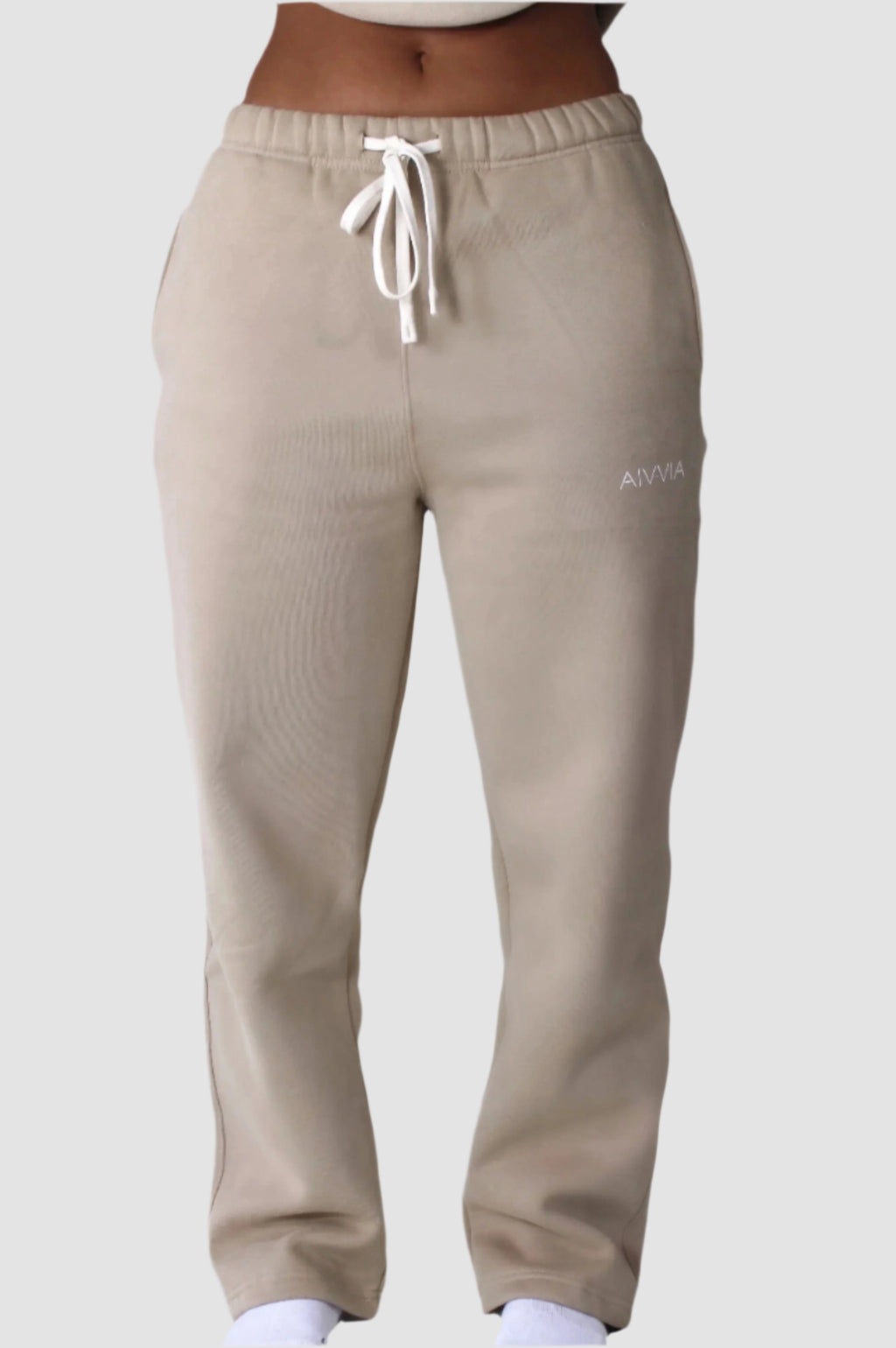 Soft beige Aivvia Athletics sweatpants in relaxed cut; versatile for loungewear or errands with a minimalist touch.