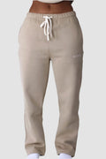 Soft beige Aivvia Athletics sweatpants in relaxed cut; versatile for loungewear or errands with a minimalist touch.