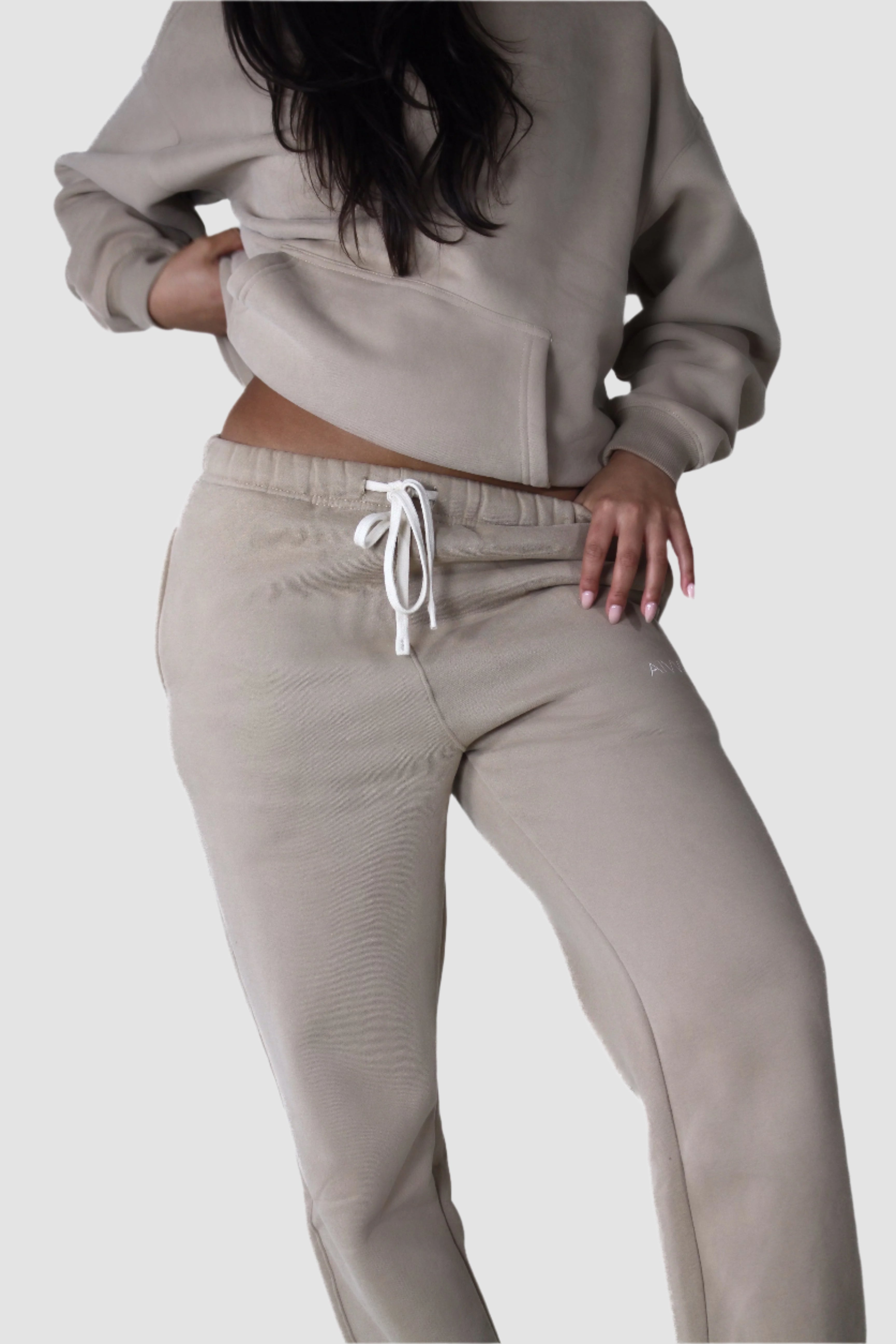 Beige Aivvia Athletics fleece sweatpants, relaxed fit women’s joggers for gym, lounge, or casual streetwear.